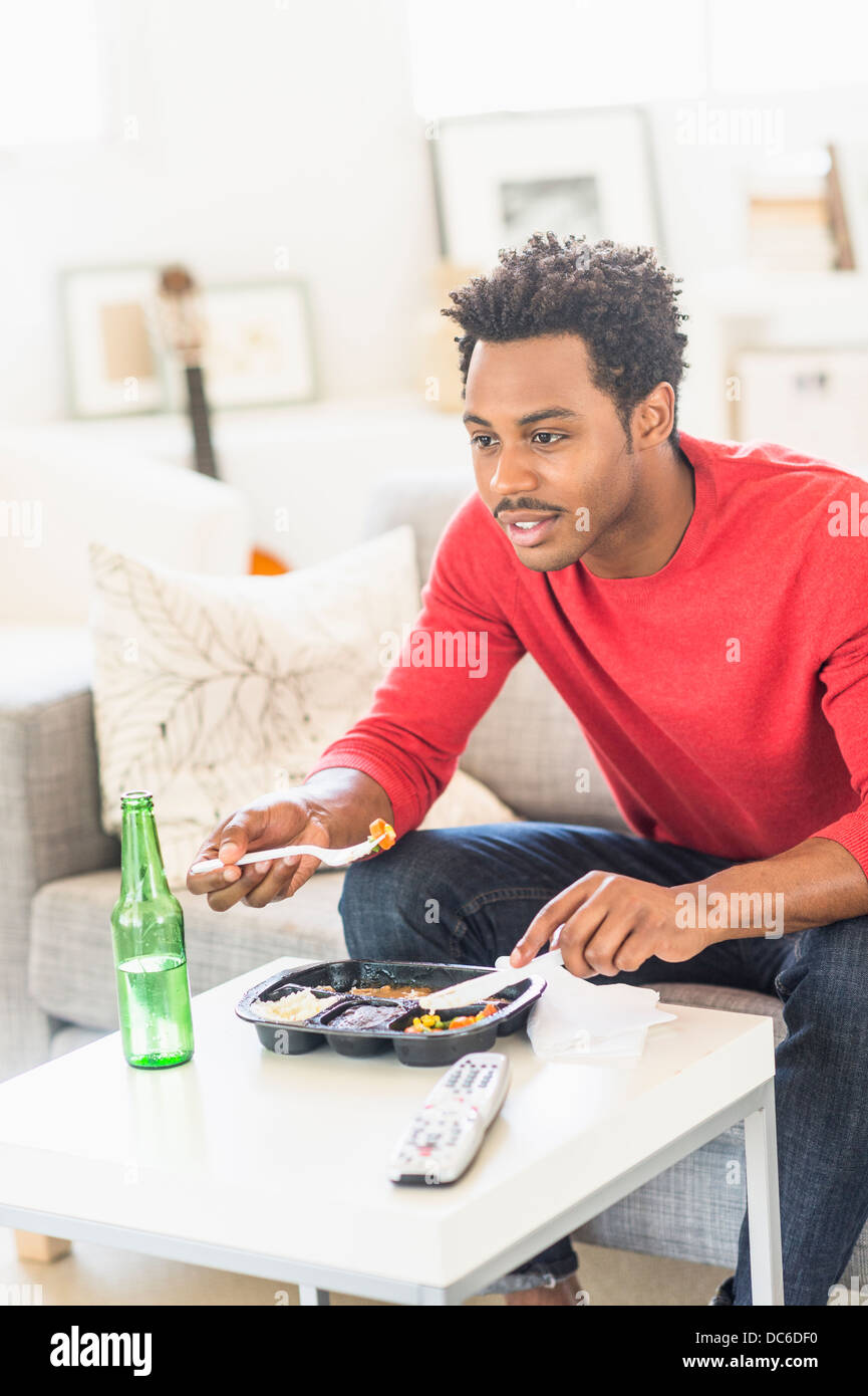 Man eating dinner and watching television Stock Photo Alamy
