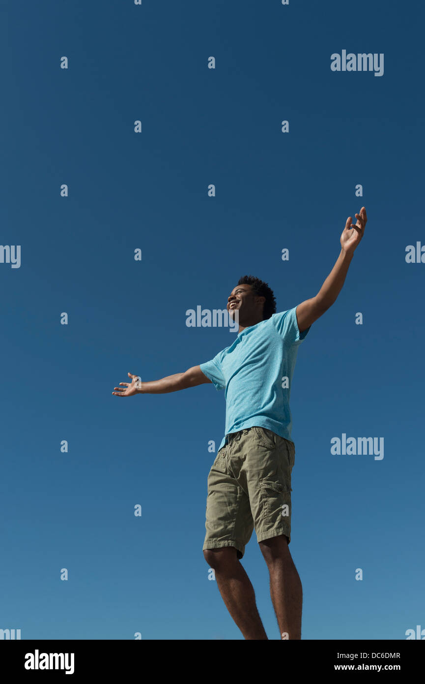 One african man jumping happy hi-res stock photography and images - Alamy