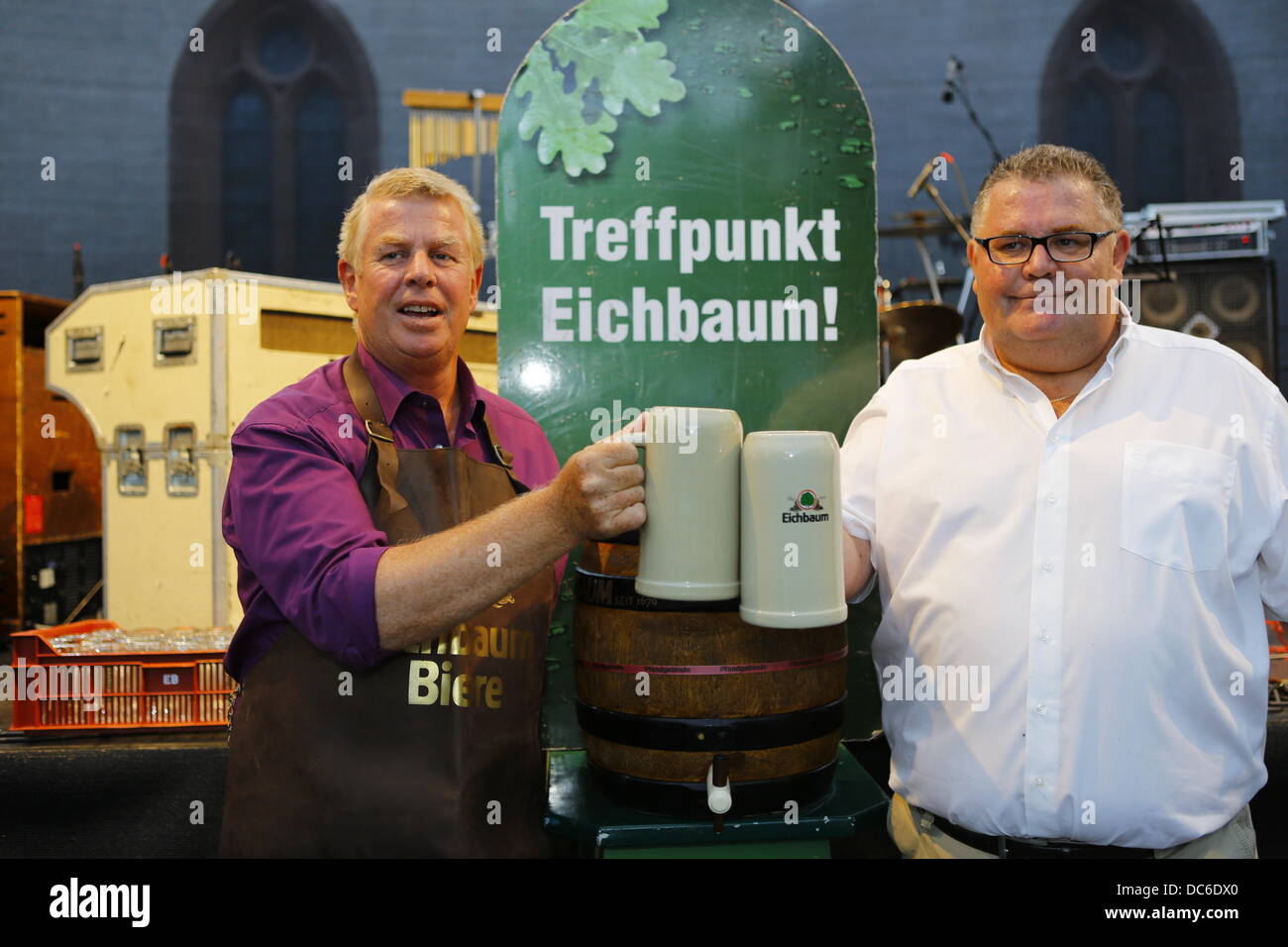 Worms, Germany. 9th August 2013. The Lord Mayor of Worms, Michael Kissel (L), touch glasses with the representative of the Eichbaum brewery (R). The Lord Mayor of Worms, Michael Kissel, opened the Jazz & Joy Festival 2013 with a traditional keg-tapping ceremony. The Jazz & Joy Festival runs for three days in the shadow of the Cathedral of Worms. Credit:  Michael Debets/Alamy Live News Stock Photo