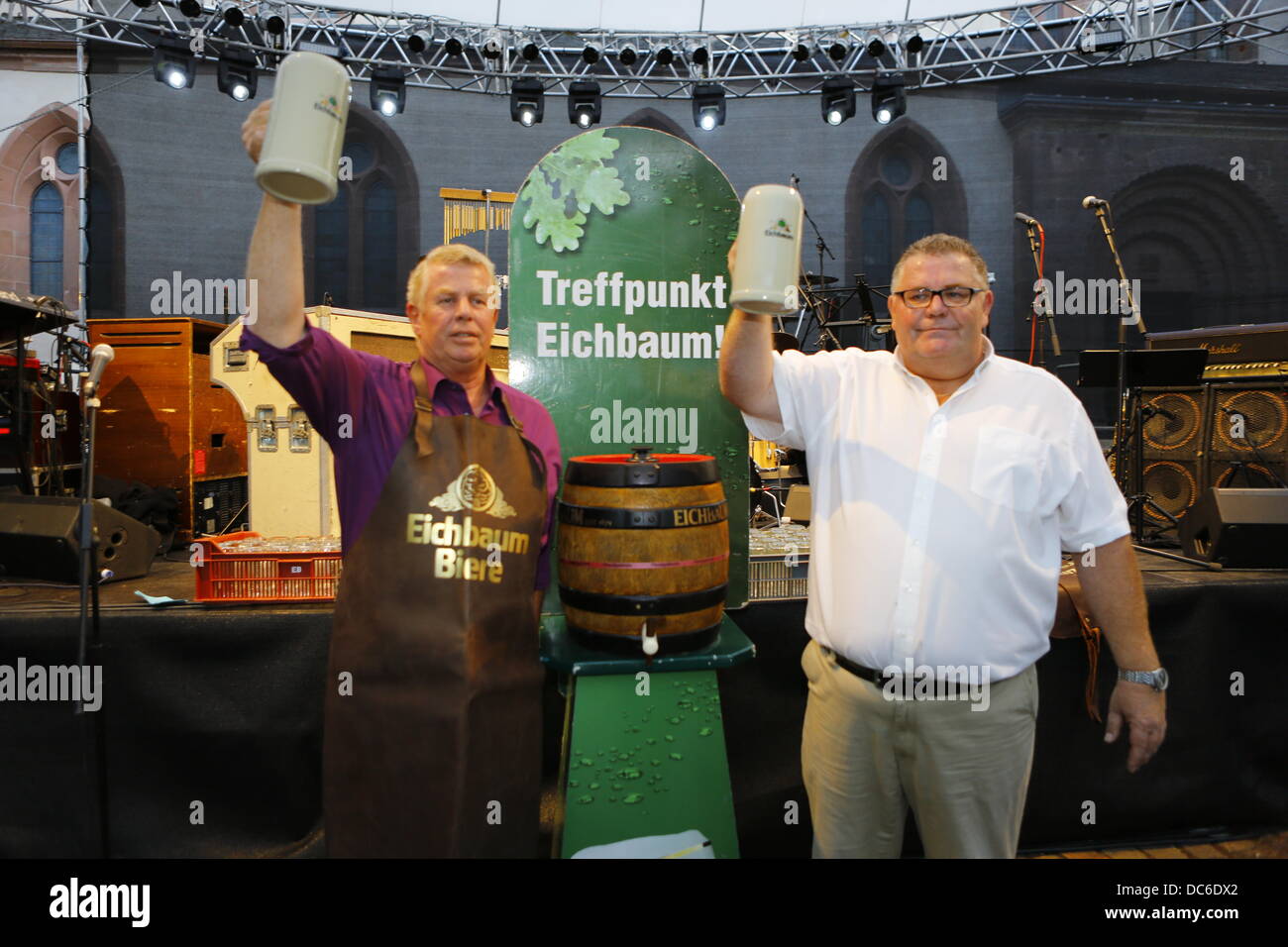 Worms, Germany. 9th August 2013. The Lord Mayor of Worms, Michael Kissel (L), and the representative of the Eichbaum brewery (R) raise their beer Steins. The Lord Mayor of Worms, Michael Kissel, opened the Jazz & Joy Festival 2013 with a traditional keg-tapping ceremony. The Jazz & Joy Festival runs for three days in the shadow of the Cathedral of Worms. Credit:  Michael Debets/Alamy Live News Stock Photo