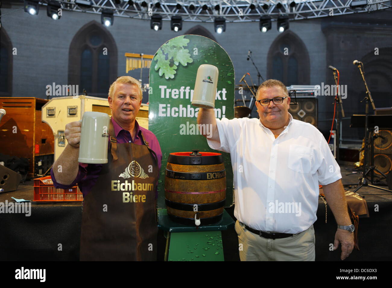 Worms, Germany. 9th August 2013. The Lord Mayor of Worms, Michael Kissel (L), and the representative of the Eichbaum brewery (R) raise their beer Steins. The Lord Mayor of Worms, Michael Kissel, opened the Jazz & Joy Festival 2013 with a traditional keg-tapping ceremony. The Jazz & Joy Festival runs for three days in the shadow of the Cathedral of Worms. Credit:  Michael Debets/Alamy Live News Stock Photo