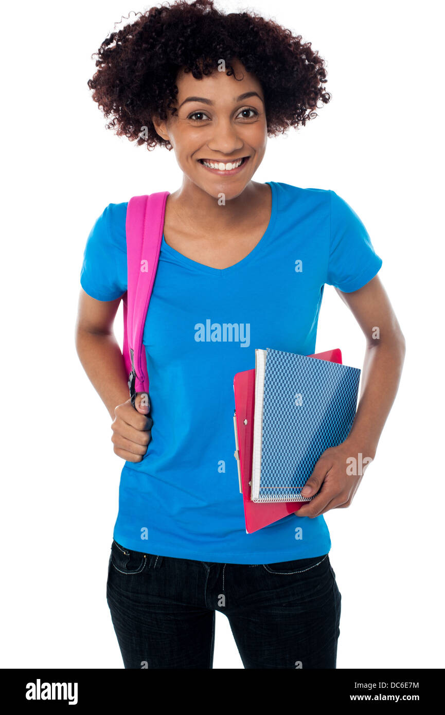 College student carrying back pack, book and clipboard Stock Photo