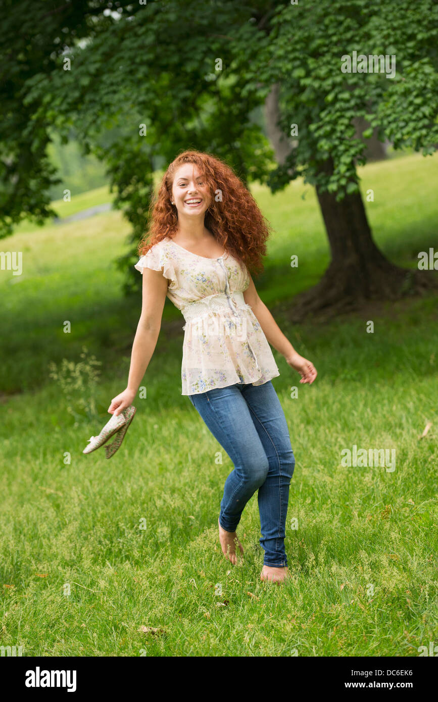 Young woman walking in park Stock Photo - Alamy