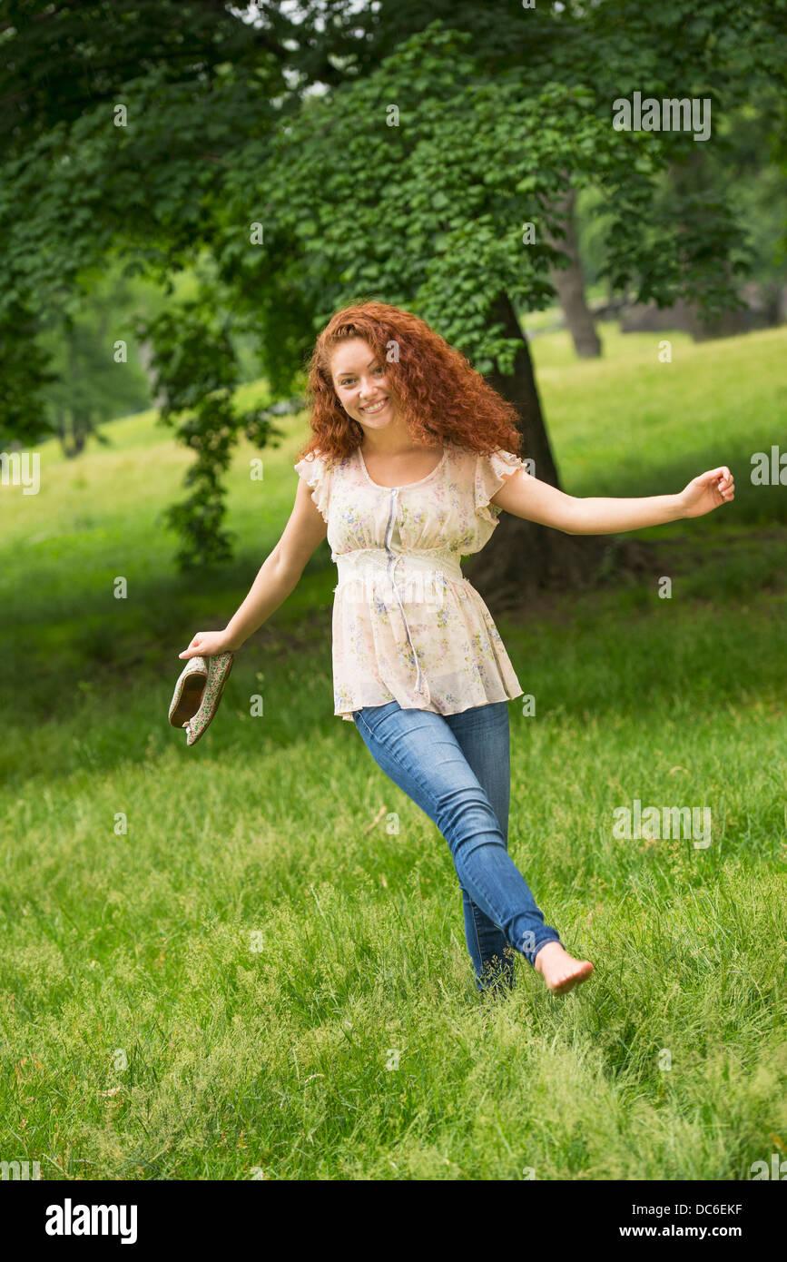 Woman walking barefoot park hi-res stock photography and images - Alamy