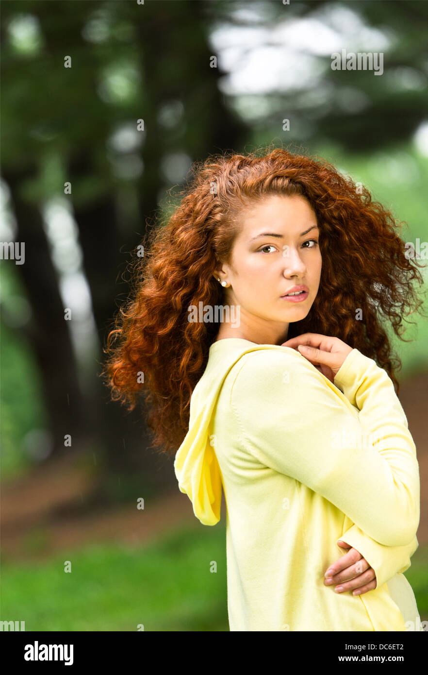 Portrait of young woman in park Stock Photo - Alamy