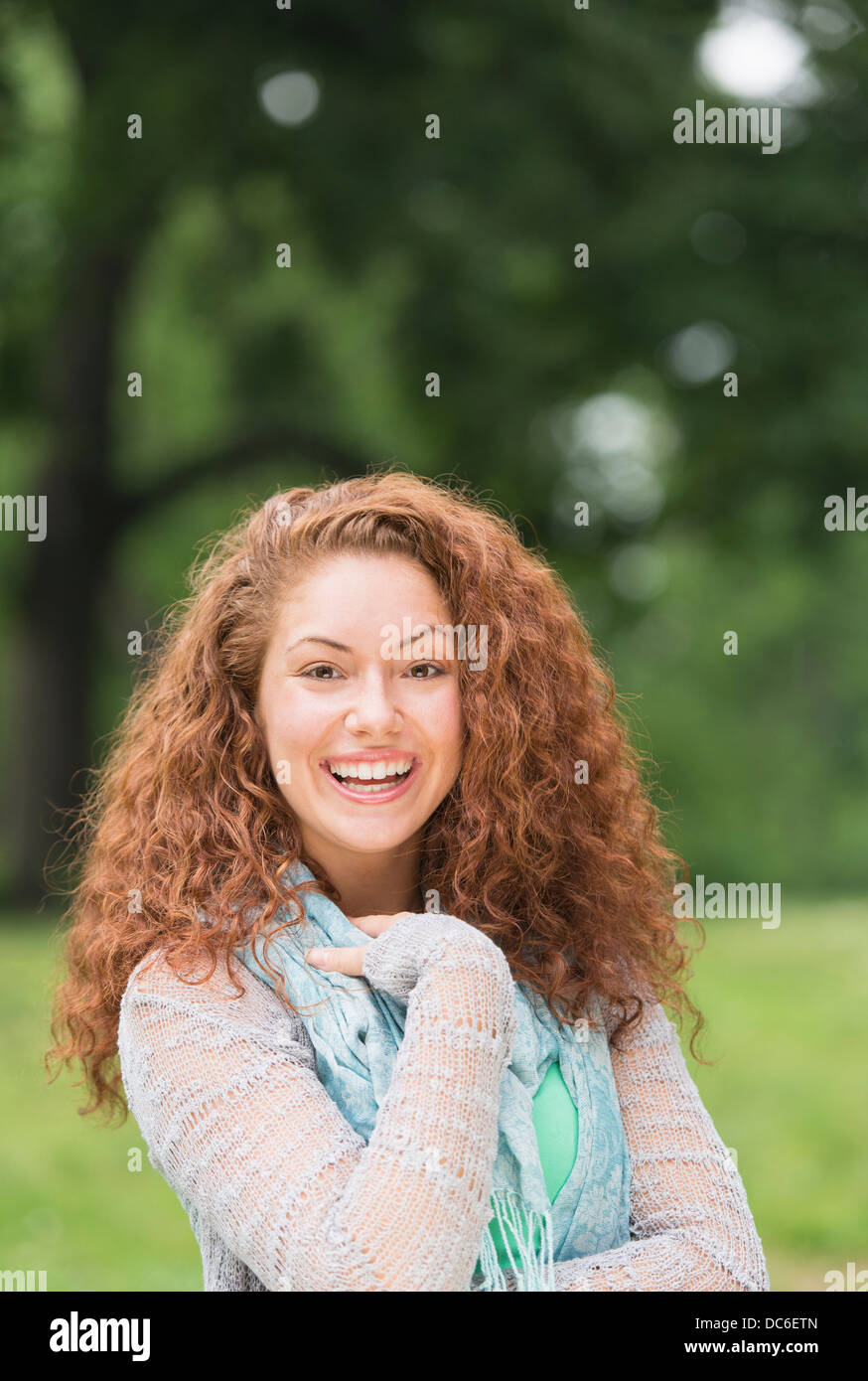 Portrait of young woman in park Stock Photo - Alamy