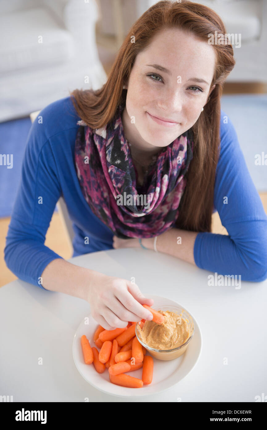 Portrait of teenage girl (14-15) with healthy snacks Stock Photo