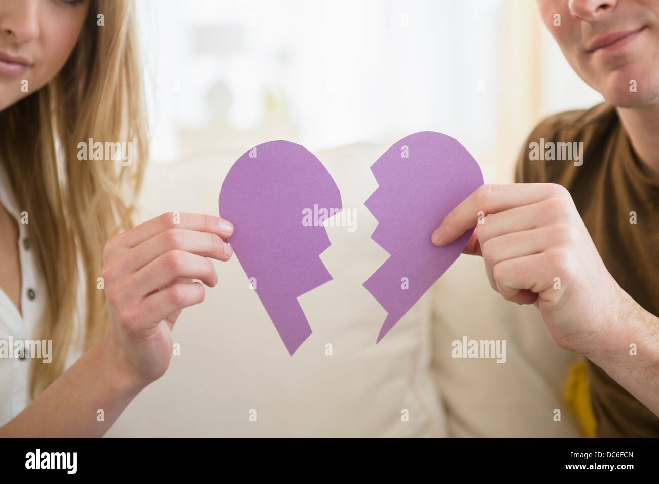 Couple holding broken heart Stock Photo