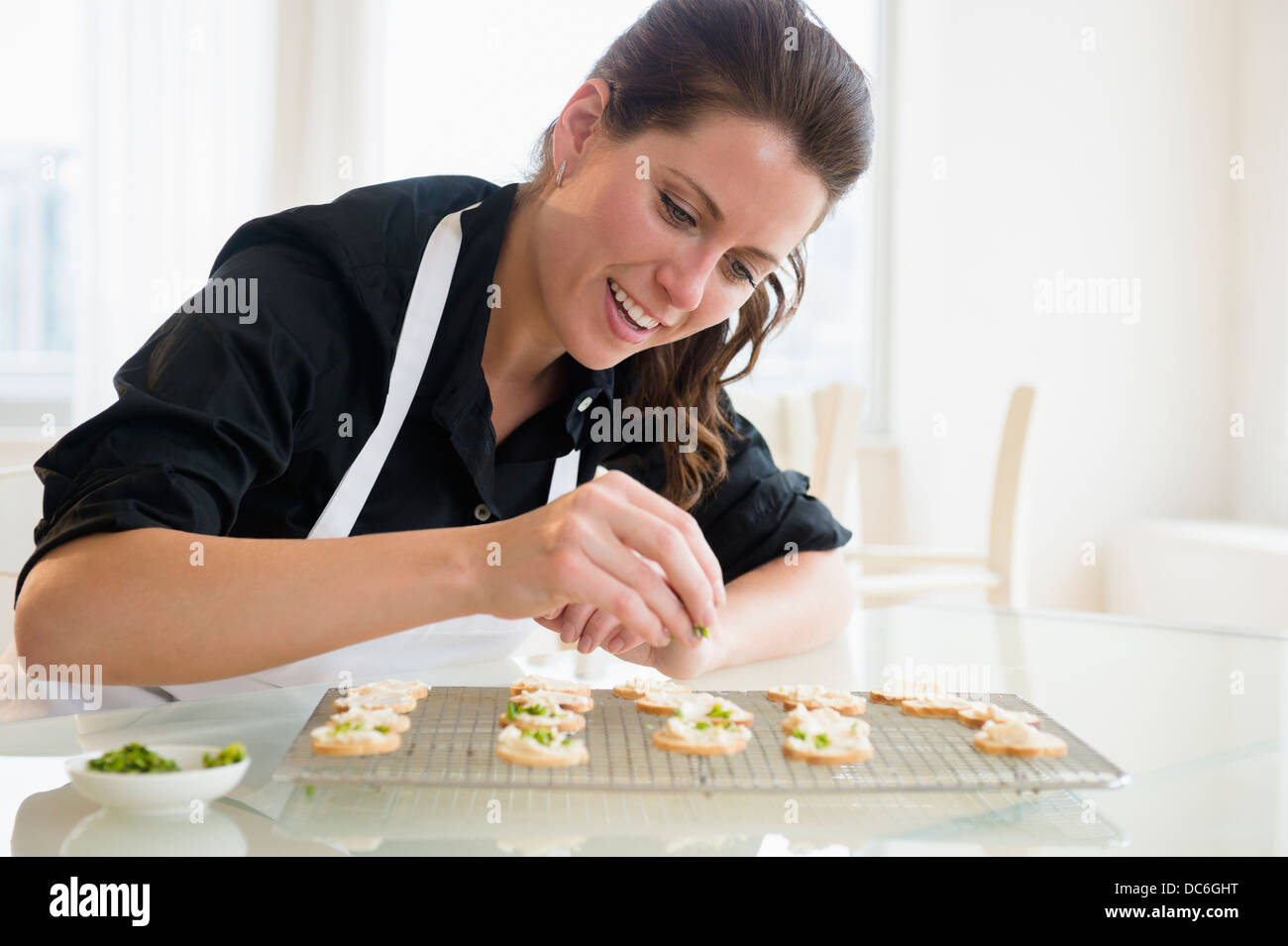 Portrait of woman preparing food Stock Photo