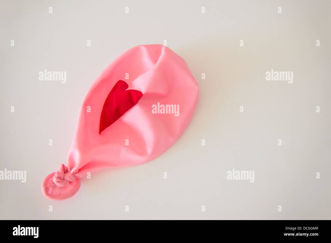 Studio Shot of deflated pink balloon Stock Photo