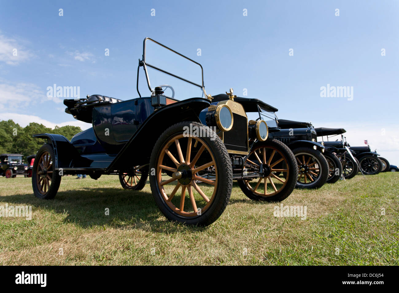 Line of Model A and Model T Ford cars, in a field. Stock Photo