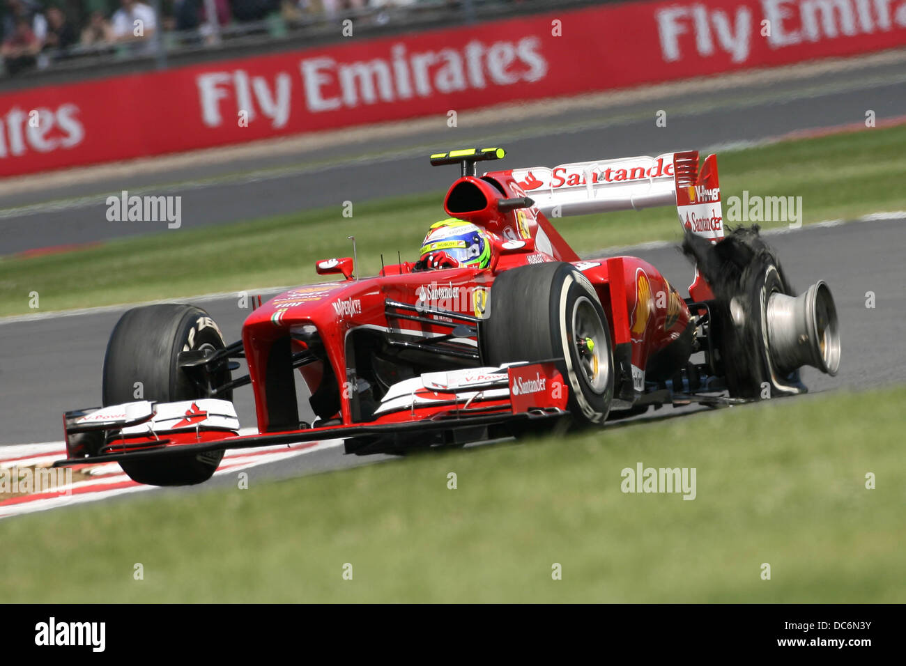 Felipe Massa's Ferrari F1 shreds his Pirelli tyre at the 2013 Formula One British Grand Prix, Silverstone. Stock Photo
