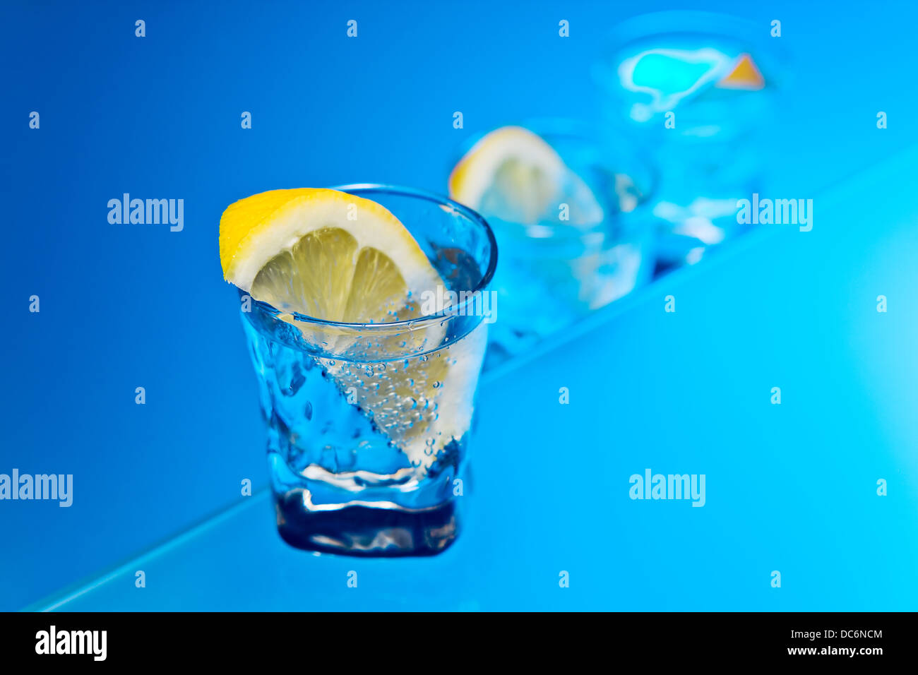 alcohol drink with lemon on a glass table Stock Photo - Alamy