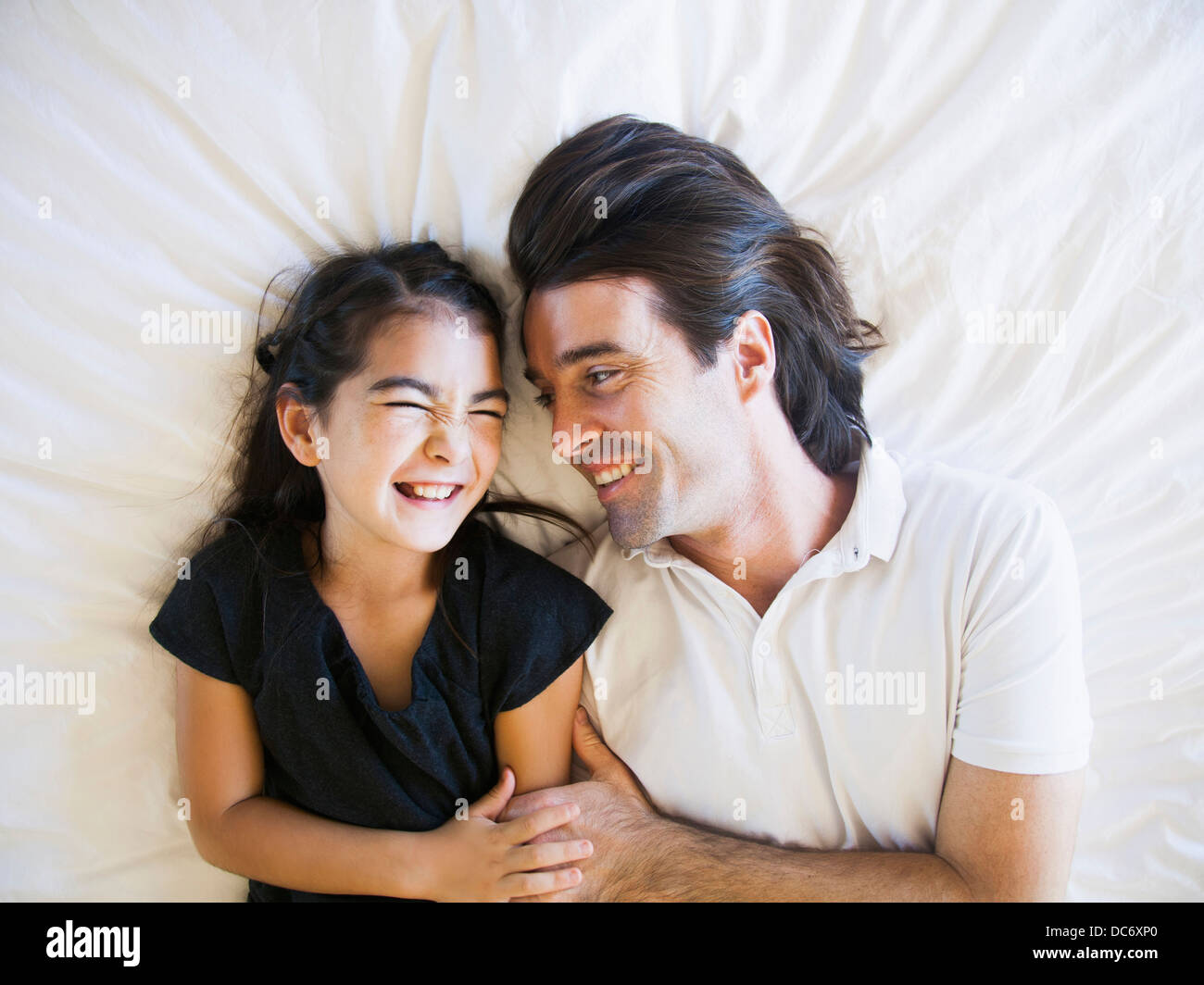 Father with daughter (8-9) laughing Stock Photo