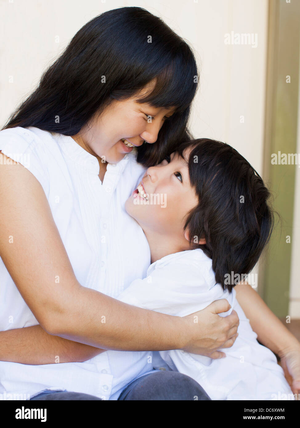Boy (8-9) embracing mother Stock Photo