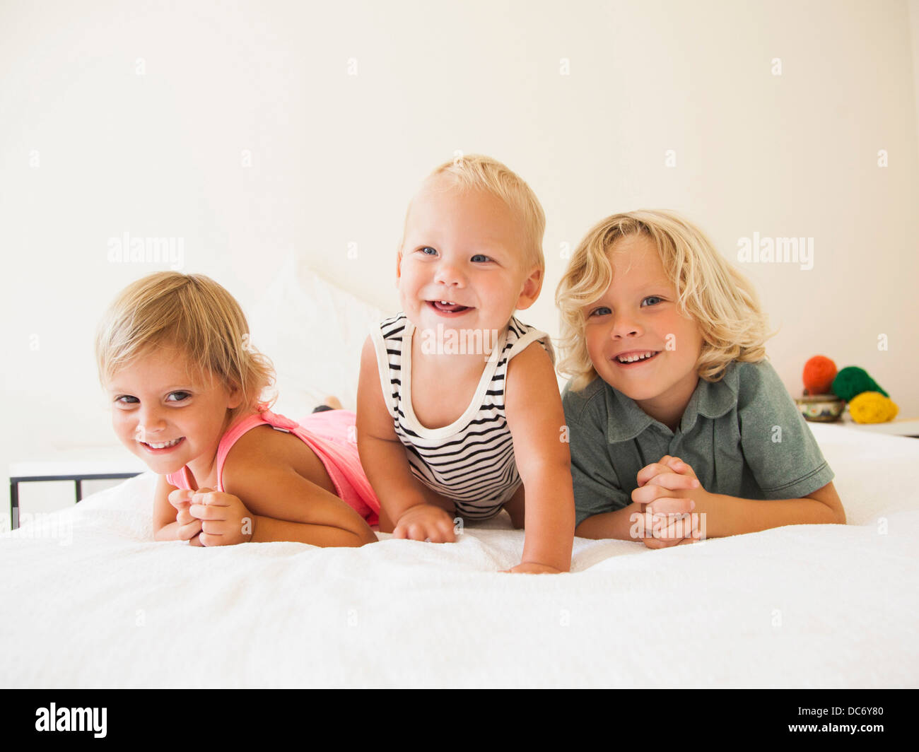 Portrait of boy (6-7), girl (2-3) and their baby brother (6-11 months) Stock Photo