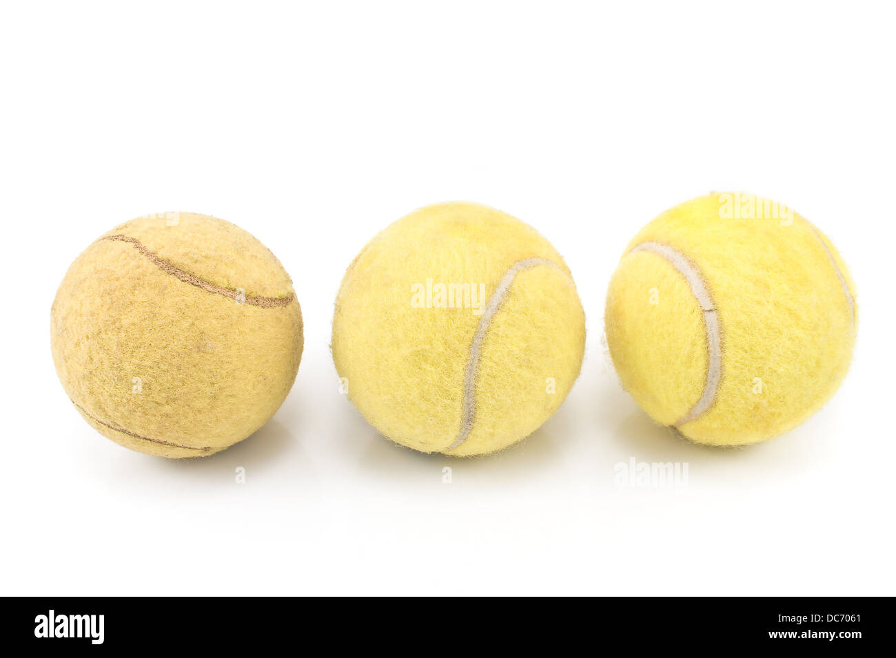 Three used tennis balls on white background Stock Photo