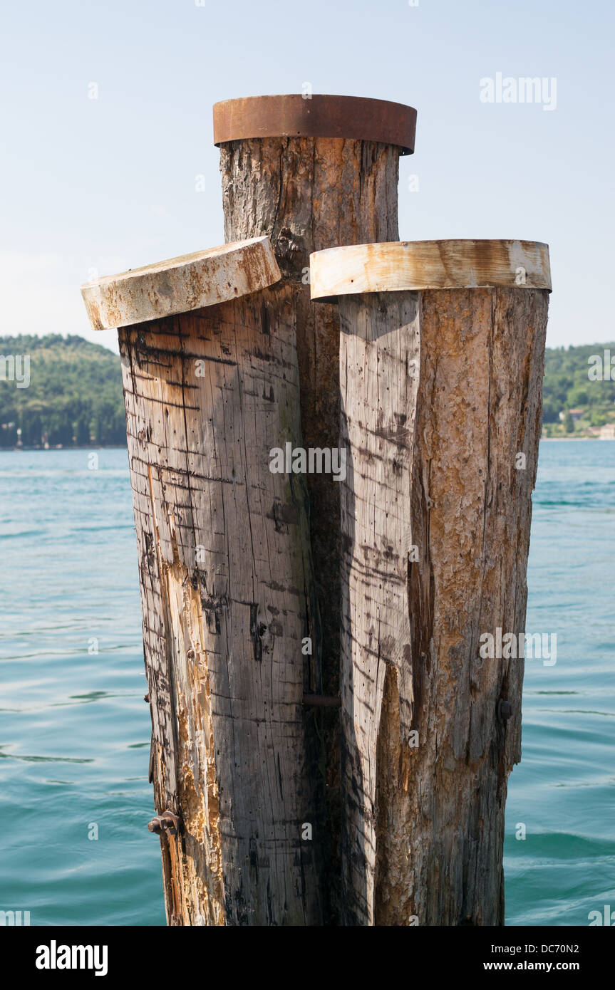 Wooden piles or moorings in lake Garda, Salo, Italy, Europe Stock Photo