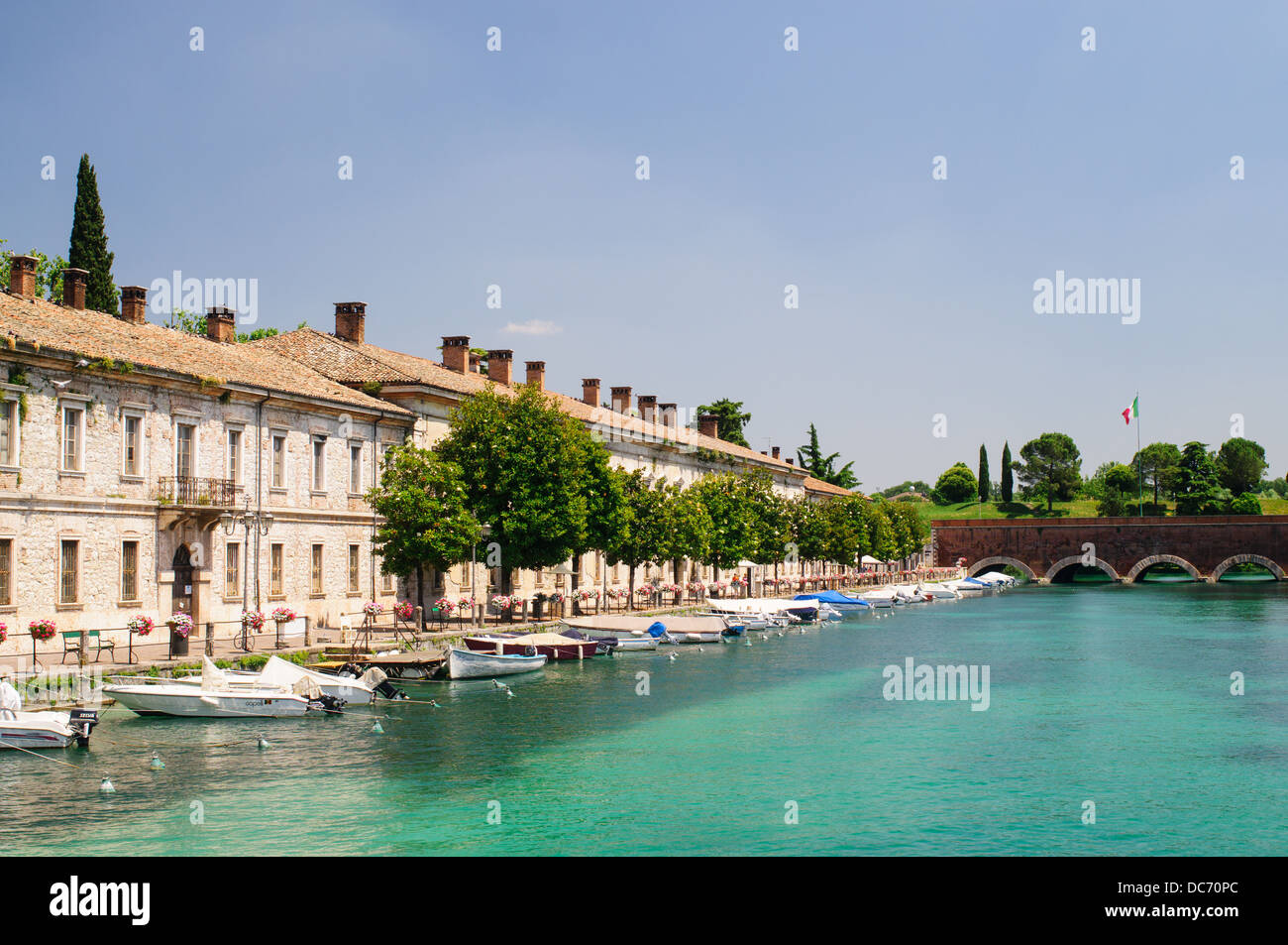Boats moored alongside the old barracks in Peschiera del Garda, Italy, Europe Stock Photo