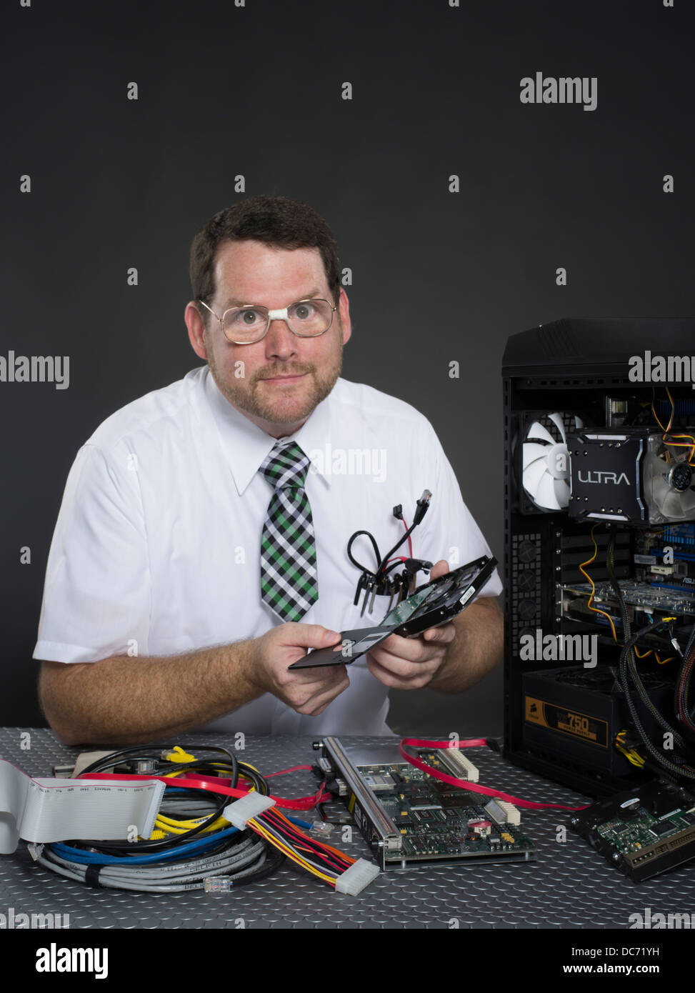 Man with computer and various hardware components Stock Photo