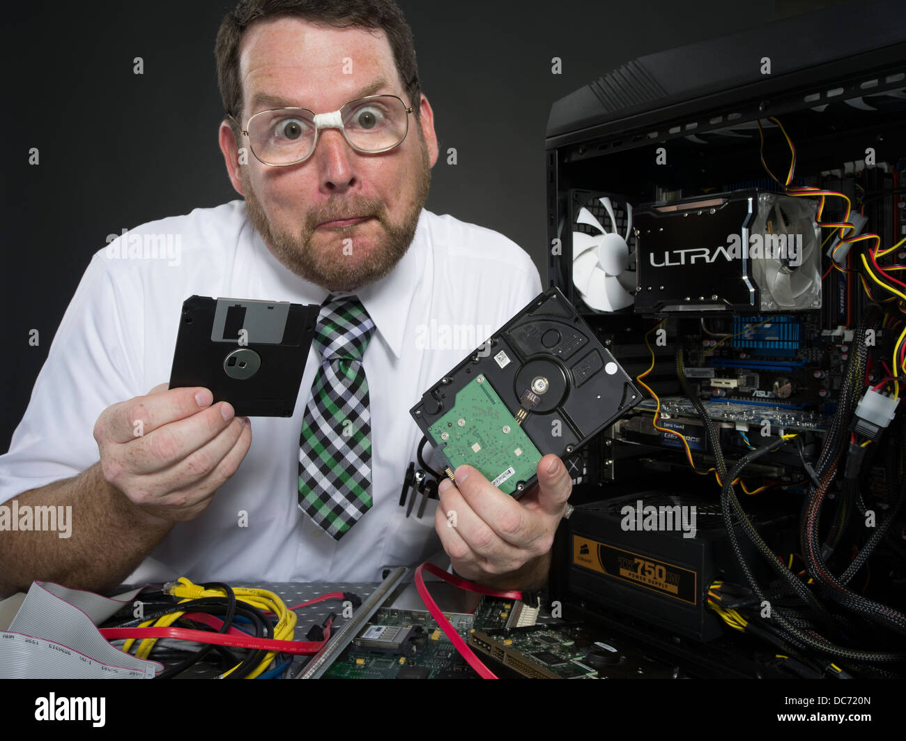Man with computer and various hardware components Stock Photo