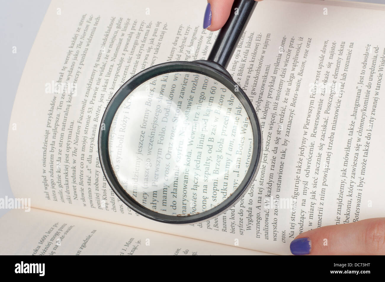 an image of magnifying glass over opened book Stock Photo - Alamy