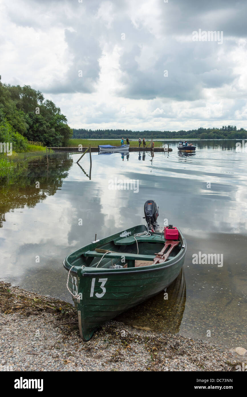 Boats at the Lake of Monteith a trout fishery near Aberfoyle Stirlingshire Trossachs Scotland with the ferry to Inchmaholme Stock Photo