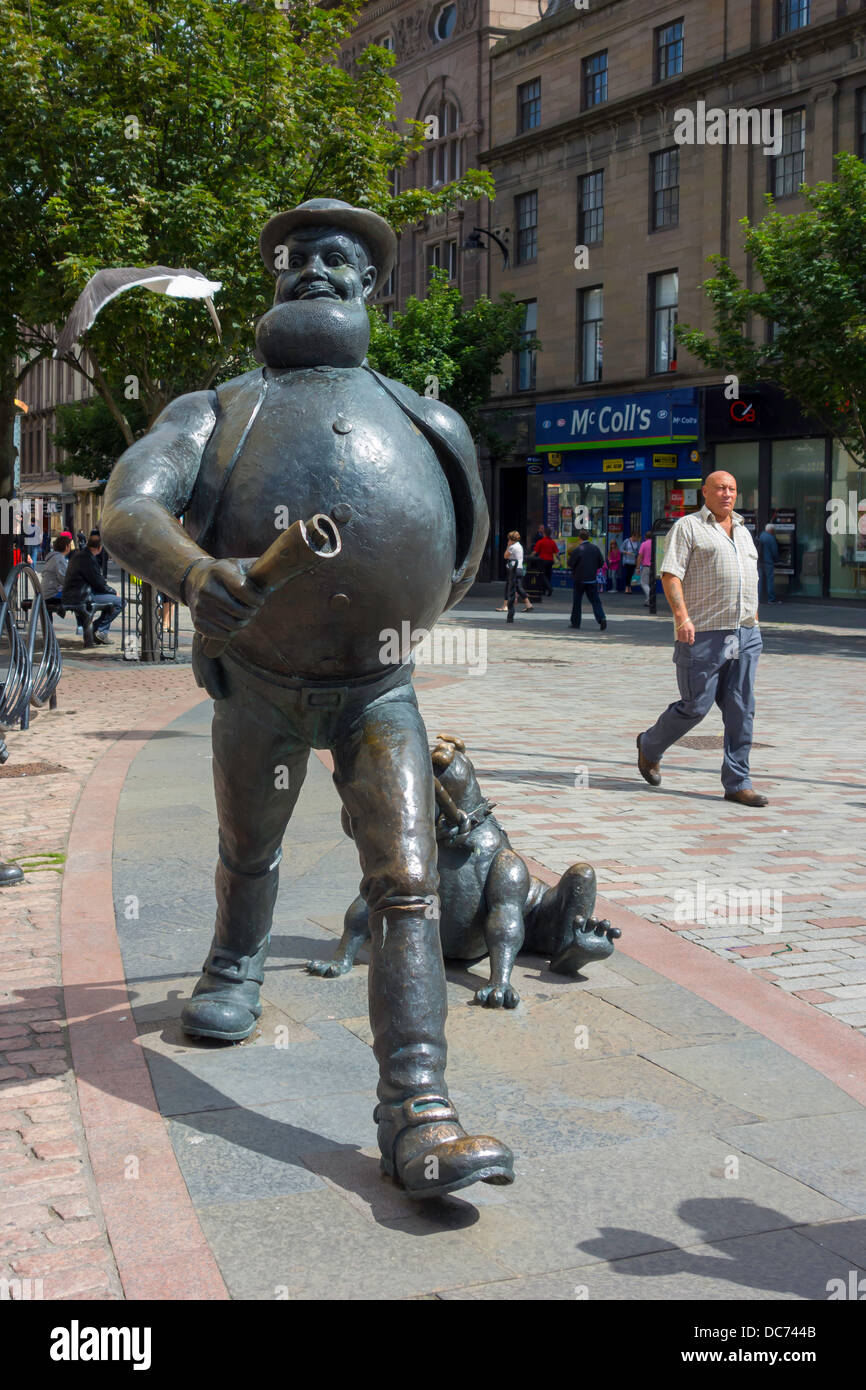 Statue of the Dandy Comic cartoon character Desperate Dan in Dundee City Centre where the comic was published with man walking Stock Photo