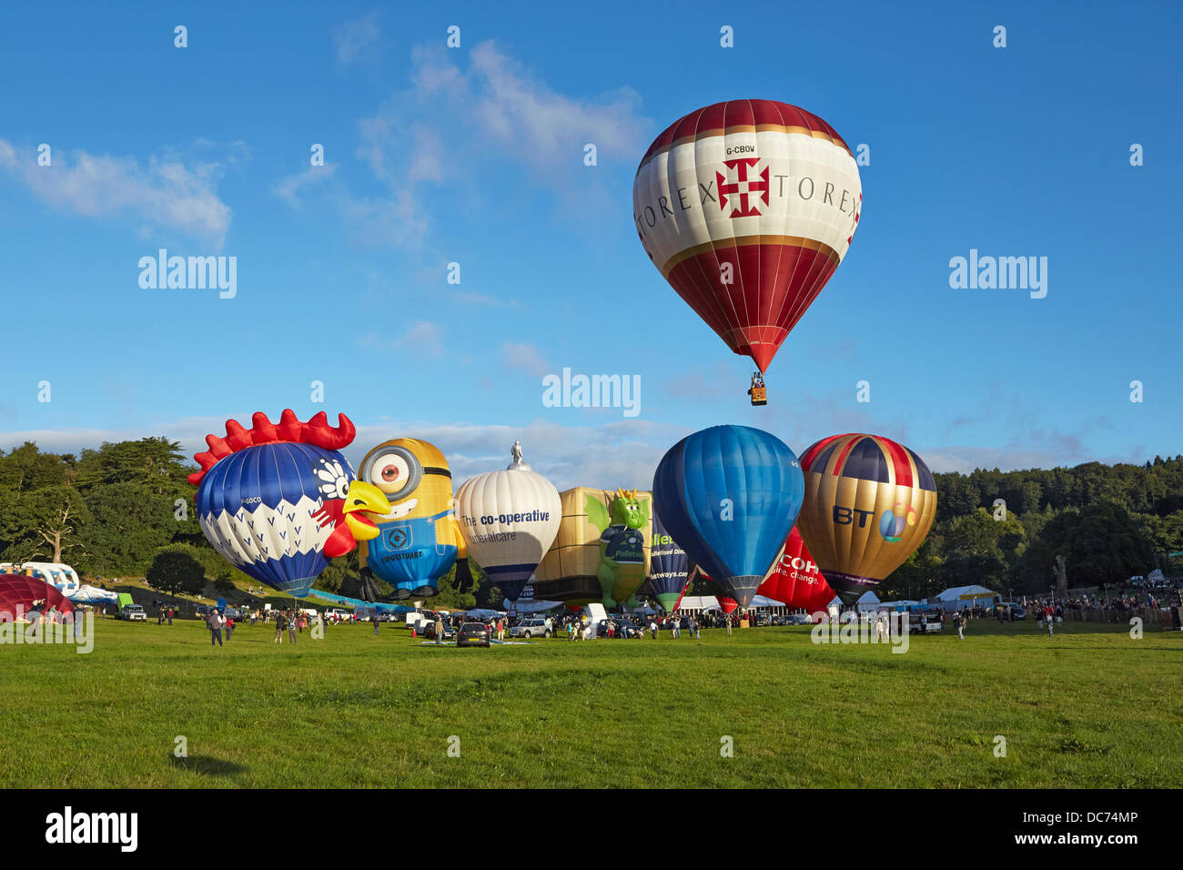 Bristol, UK. 9th Aug, 2013. Balloons at the 35th UK Bristol balloon fiesta at the Ashton court estate Morning launch launch on the 9th August 2013 including the BT FT Ricoh Palletways an Despicable Me Stuart minion balloons with a balloon taking off Credit:  David Lyon/Alamy Live News Stock Photo
