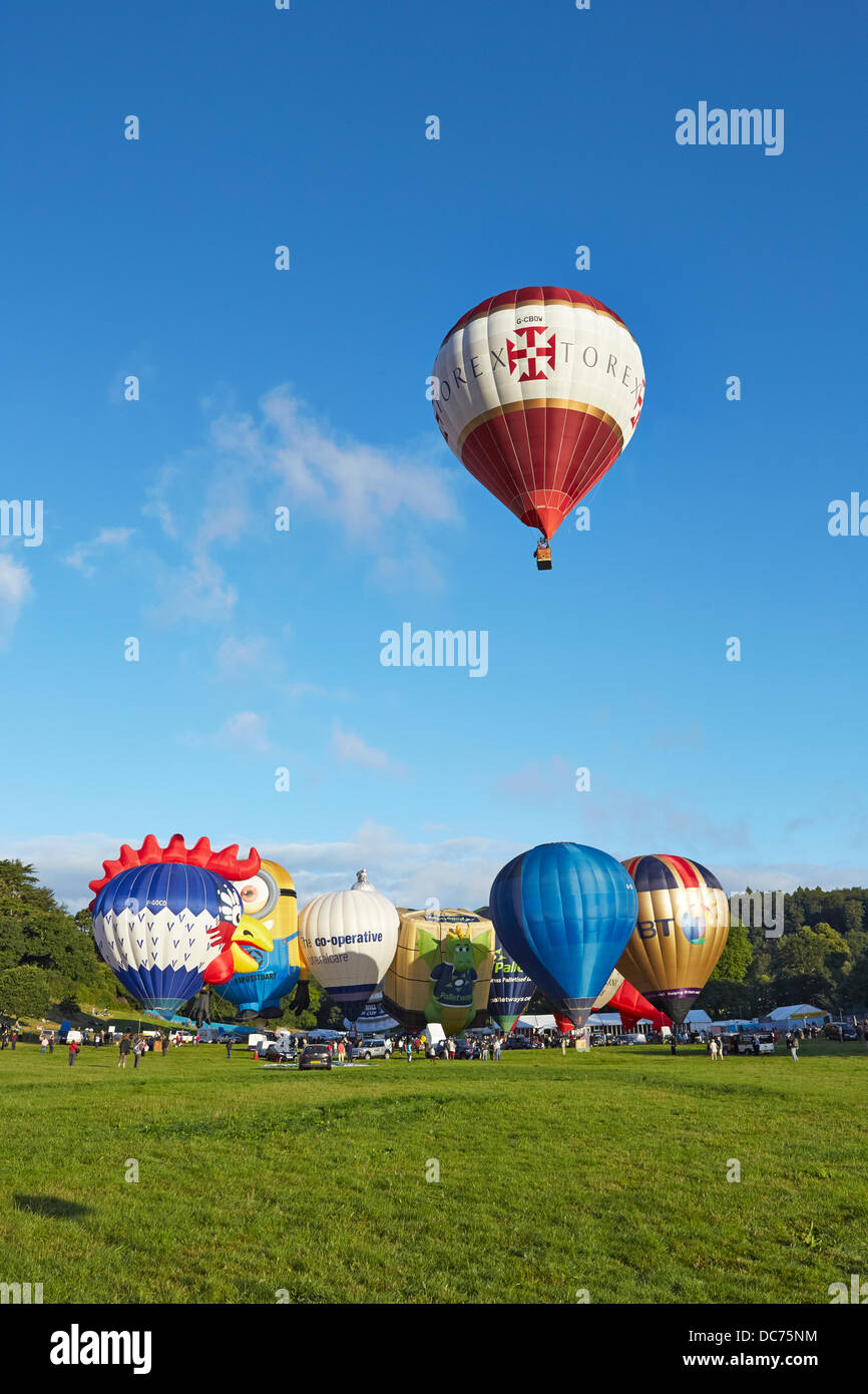 Bristol, UK. 9th Aug, 2013. Balloons at the 35th UK Bristol balloon fiesta at the Ashton court estate Morning launch launch on the 9th August 2013 including the BT FT Ricoh Palletways an Despicable Me Stuart minion balloons with a balloon taking off Credit:  David Lyon/Alamy Live News Stock Photo