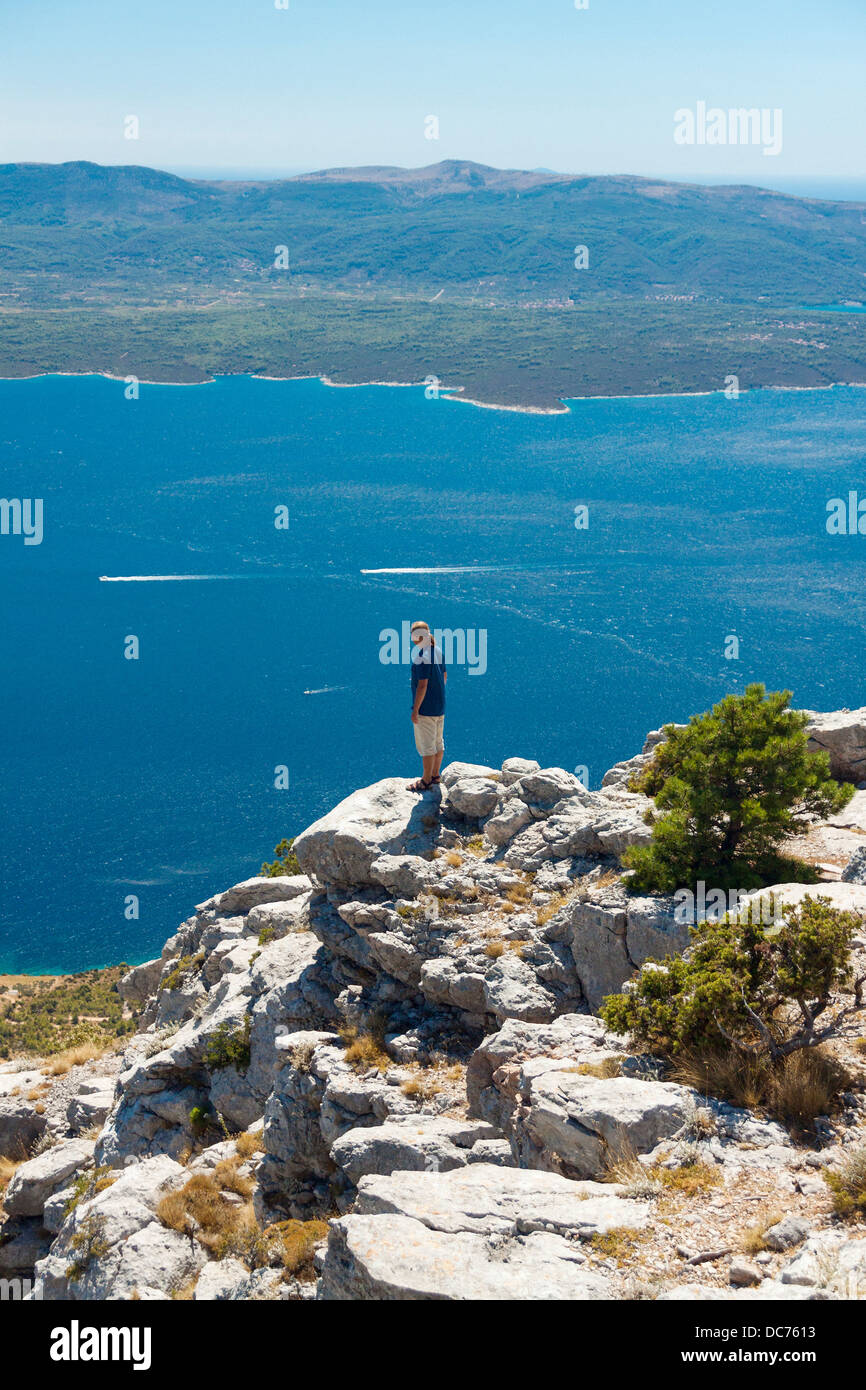 Tourist observing Hvar Channel from Vidova Gora, Croatia Stock Photo