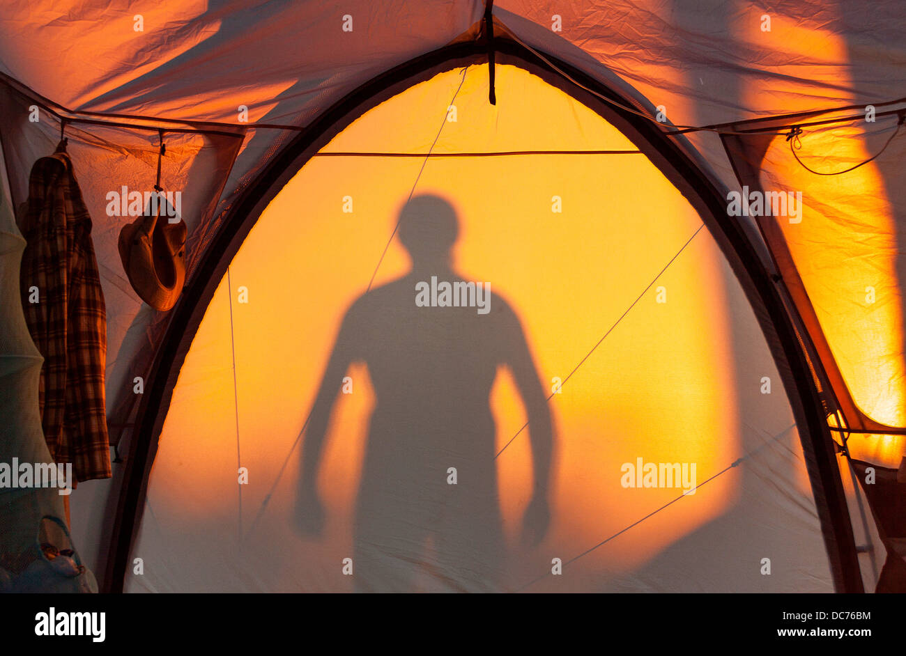 Silhouette a man on a tent Stock Photo