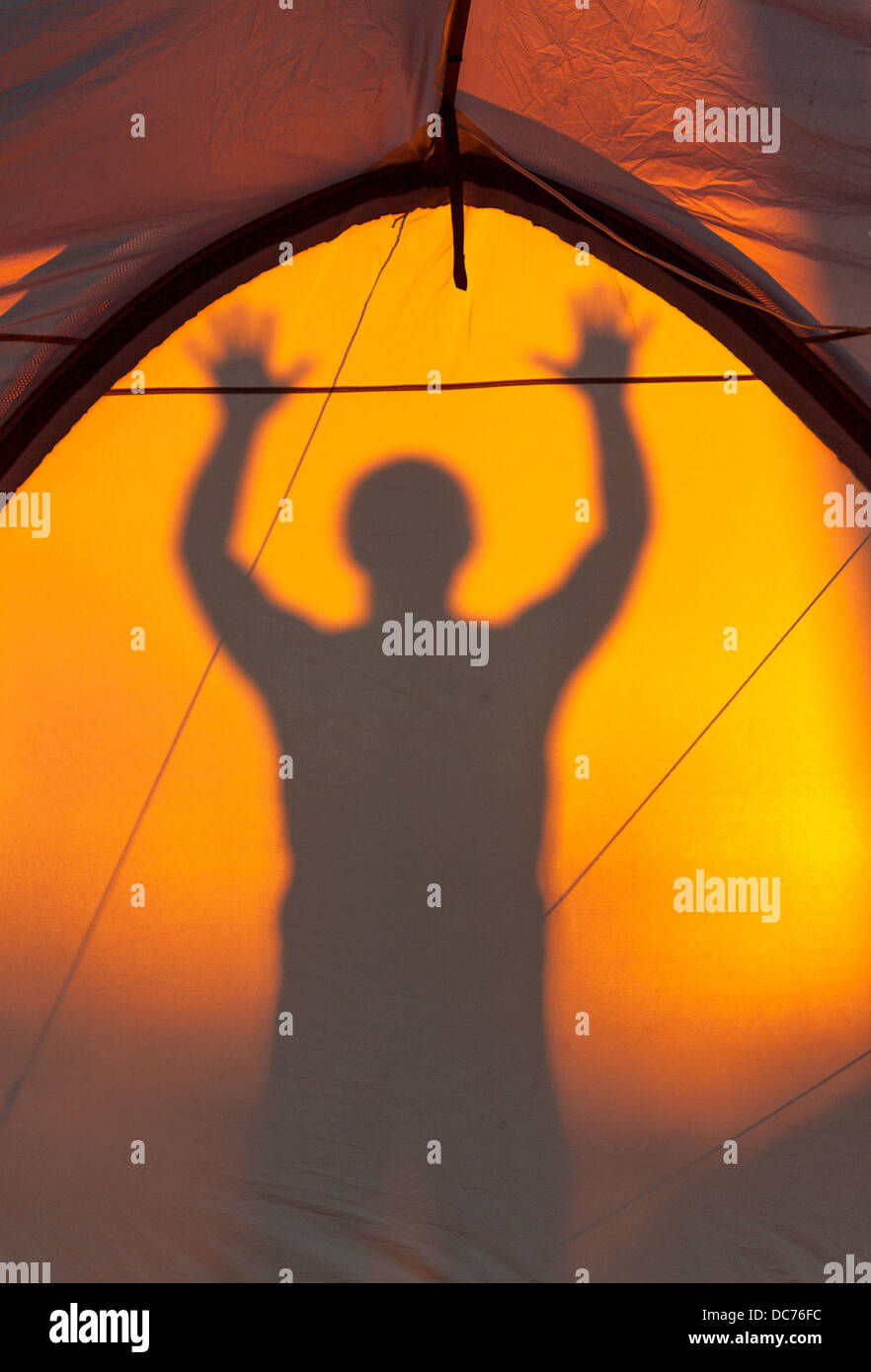 Silhouette of man frightening reflected on a tent Stock Photo