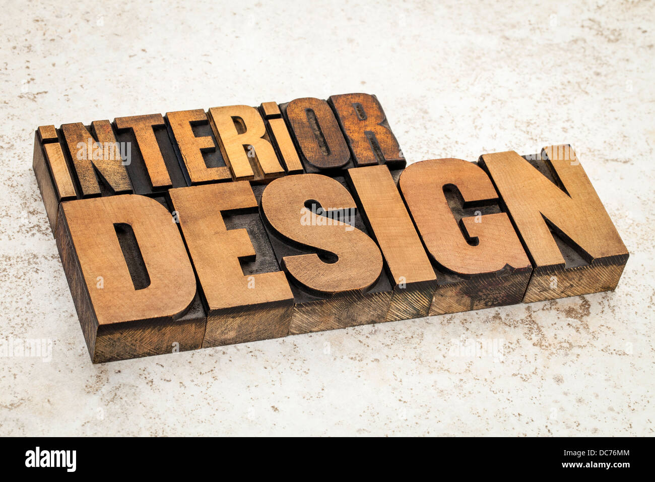 interior design text in vintage letterpress wood type on a ceramic tile background Stock Photo