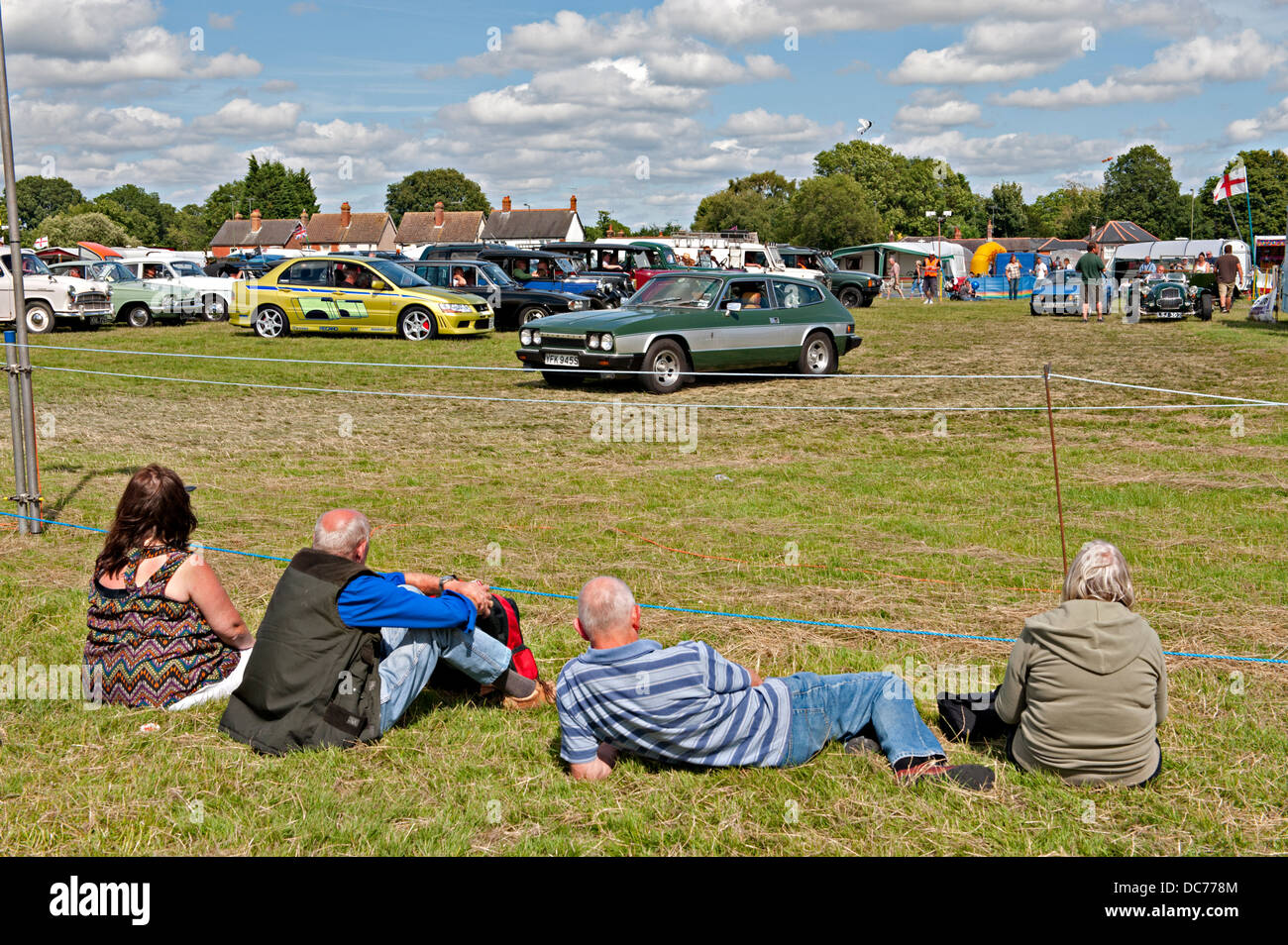 Spectators watch as old vehicles are displayed at a transport fair in Lingfield, Sussex, UK Stock Photo