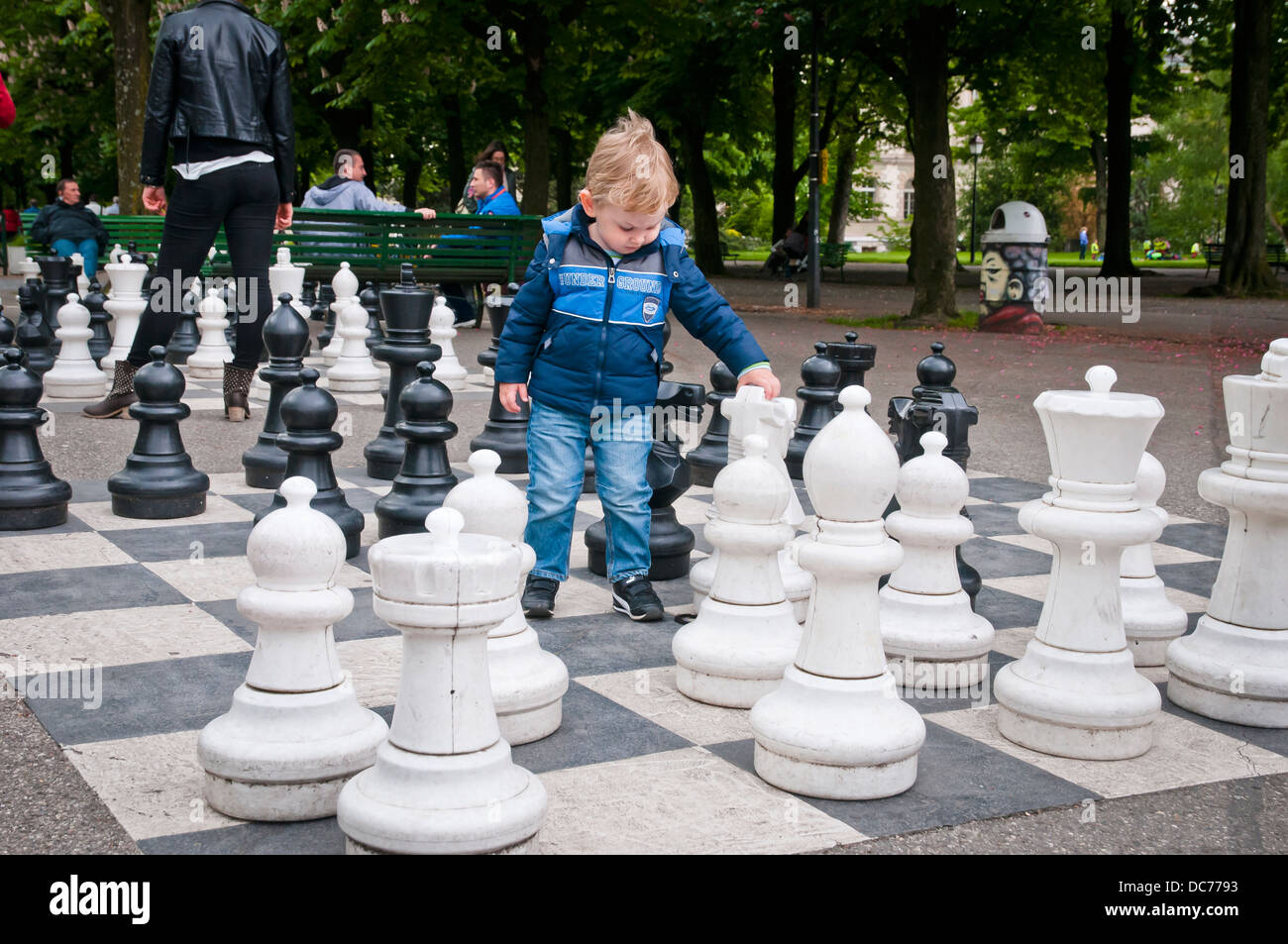 Boy interchanges giant chess pieces in Geneva park, Switzerland, Europe  Stock Photo - Alamy