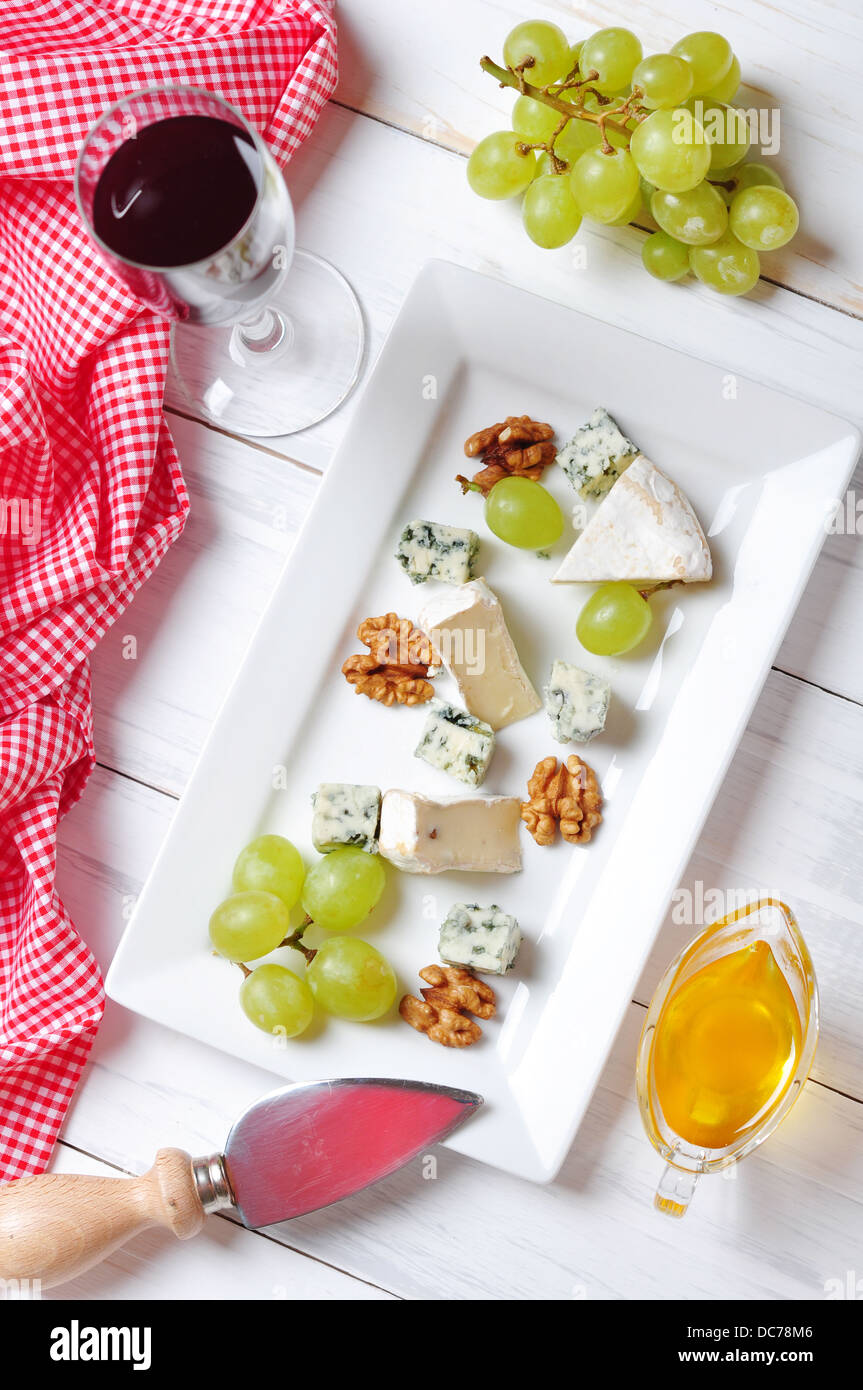 Camembert and blue cheese on plate with grape and walnut. Top view. Stock Photo