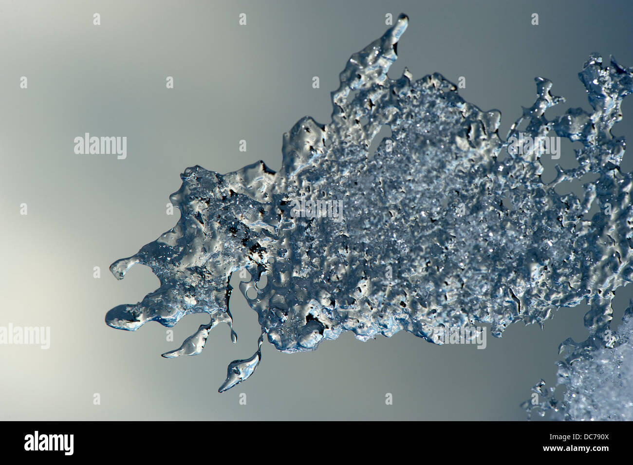 Ice patterns on the edge of melting snow. Stock Photo