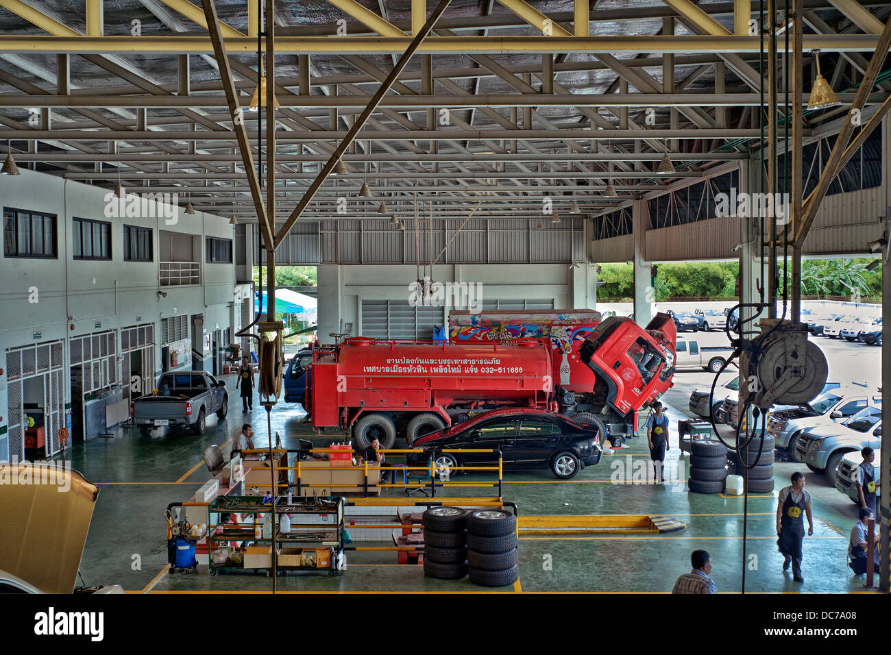 Car workshop. Overhead interior view of a large modern car and truck garage workshop. Thailand S. E. Asia. Stock Photo