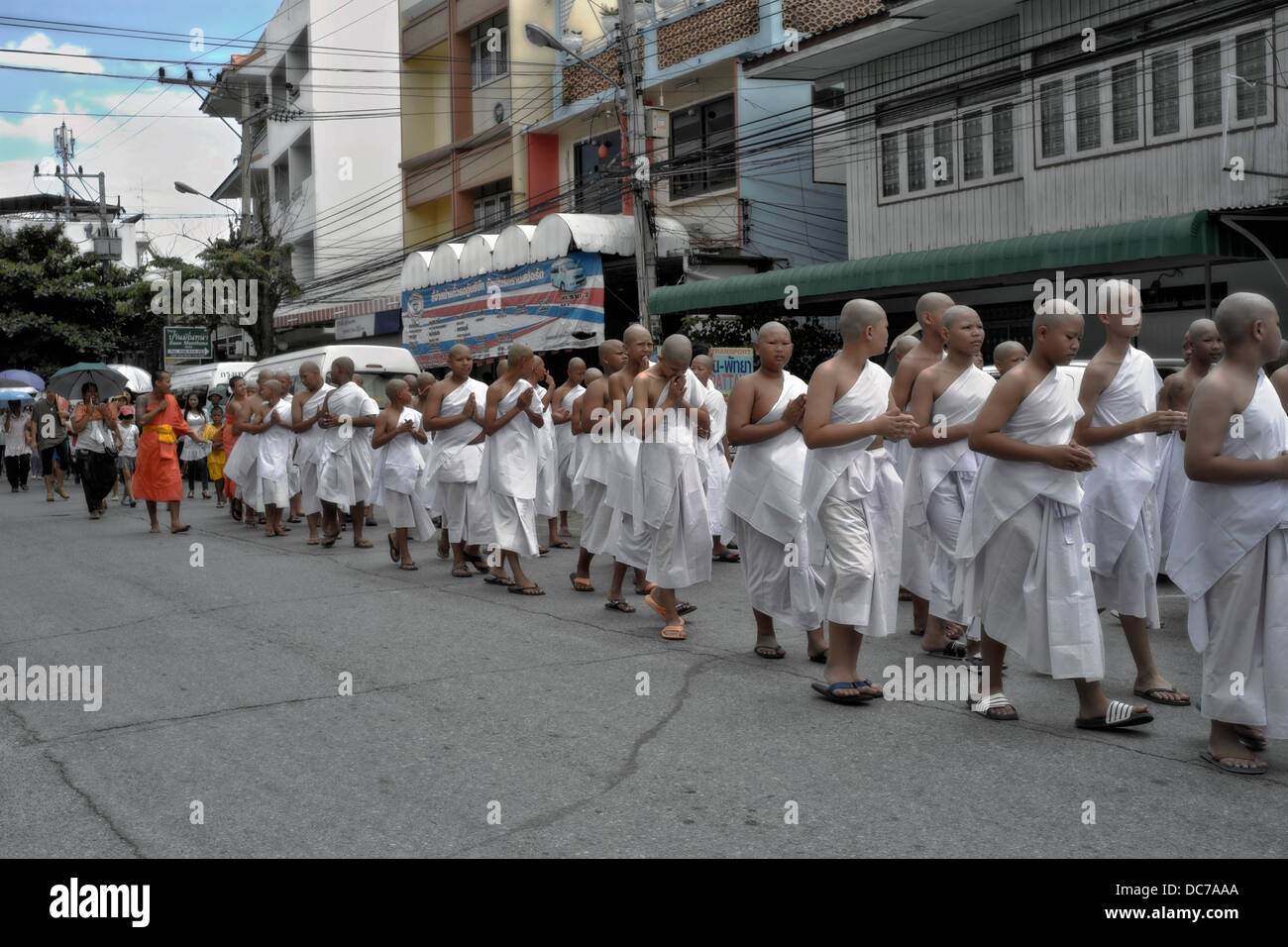 Thailand boy Monks. Buddhist novice monks parading through the street en-route to their ordination ceremony. Thailand S. E. Asia. Stock Photo