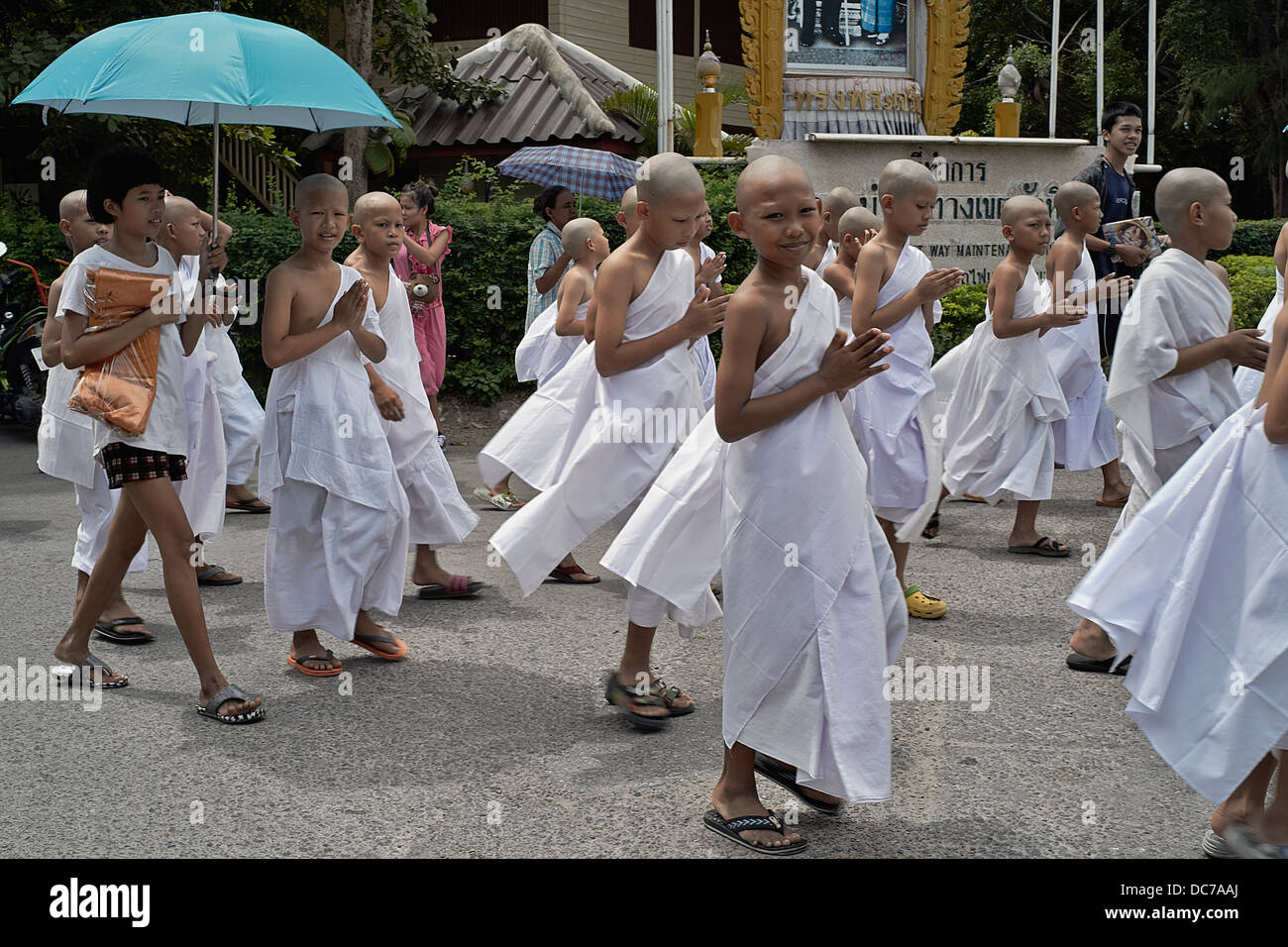 Thailand boy Monks. Buddhist novice monks parading through the street en-route to their ordination ceremony. Thailand S. E. Asia. Stock Photo