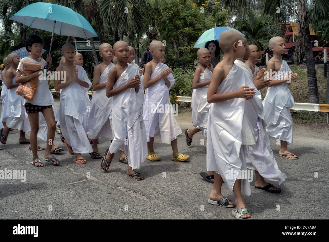 Thailand boy Monks. Buddhist novice monks parading through the street en-route to their ordination ceremony. Thailand S. E. Asia. Stock Photo