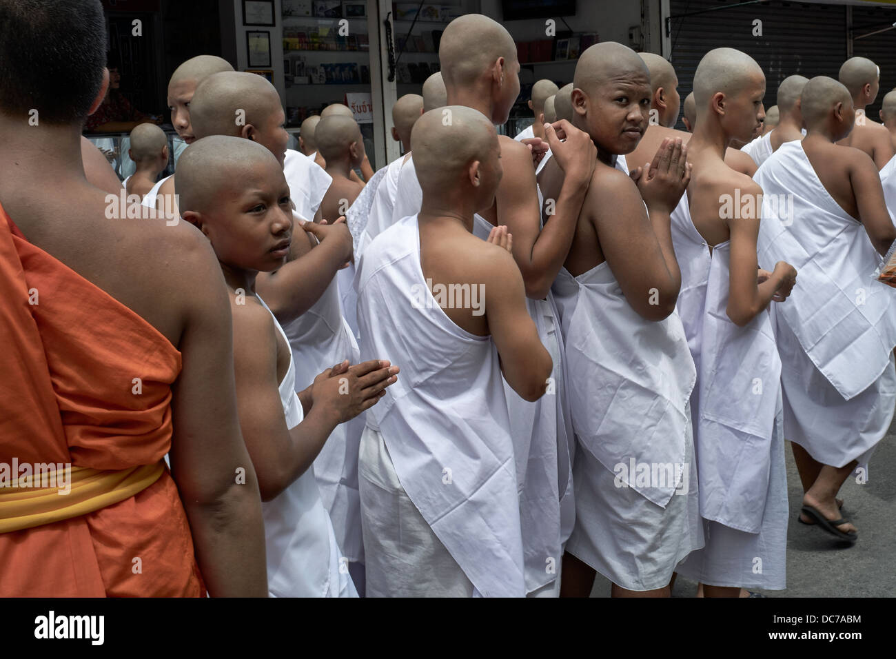 Thailand boy Monks. Buddhist novice monks parading through the street en-route to their ordination ceremony. Thailand S. E. Asia. Stock Photo