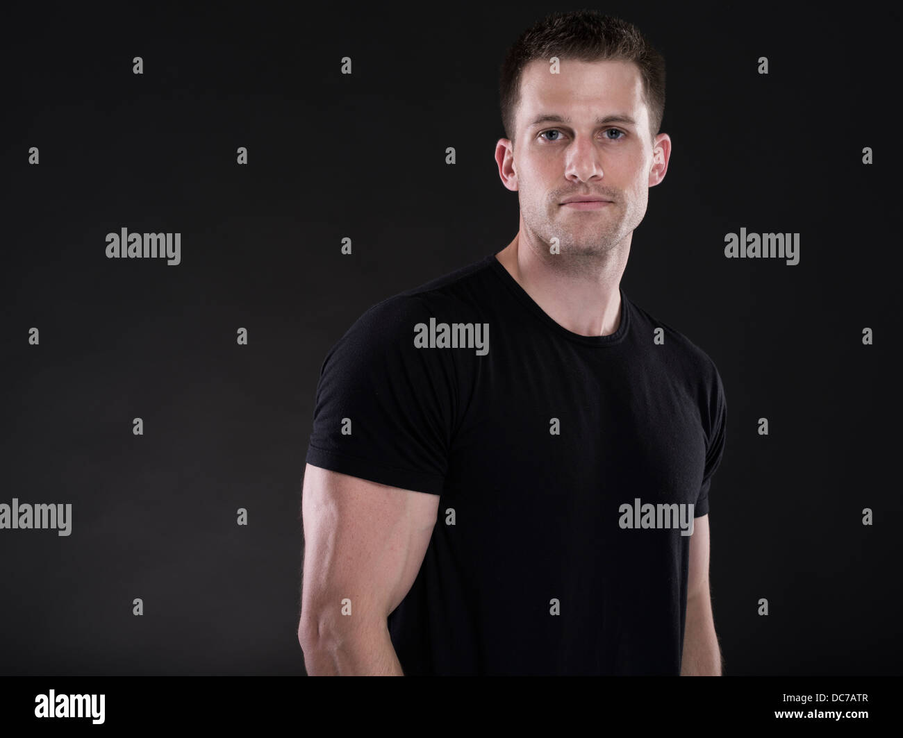 Handsome Caucasian man in his twenties wearing plain black t-shirt Stock Photo