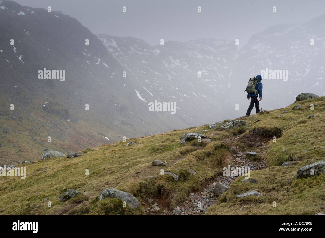 Hiker / Rambler ascending Glaramara -  Lake District National Park, Cumbria, England, Great Britain, The United Kingdom. Stock Photo