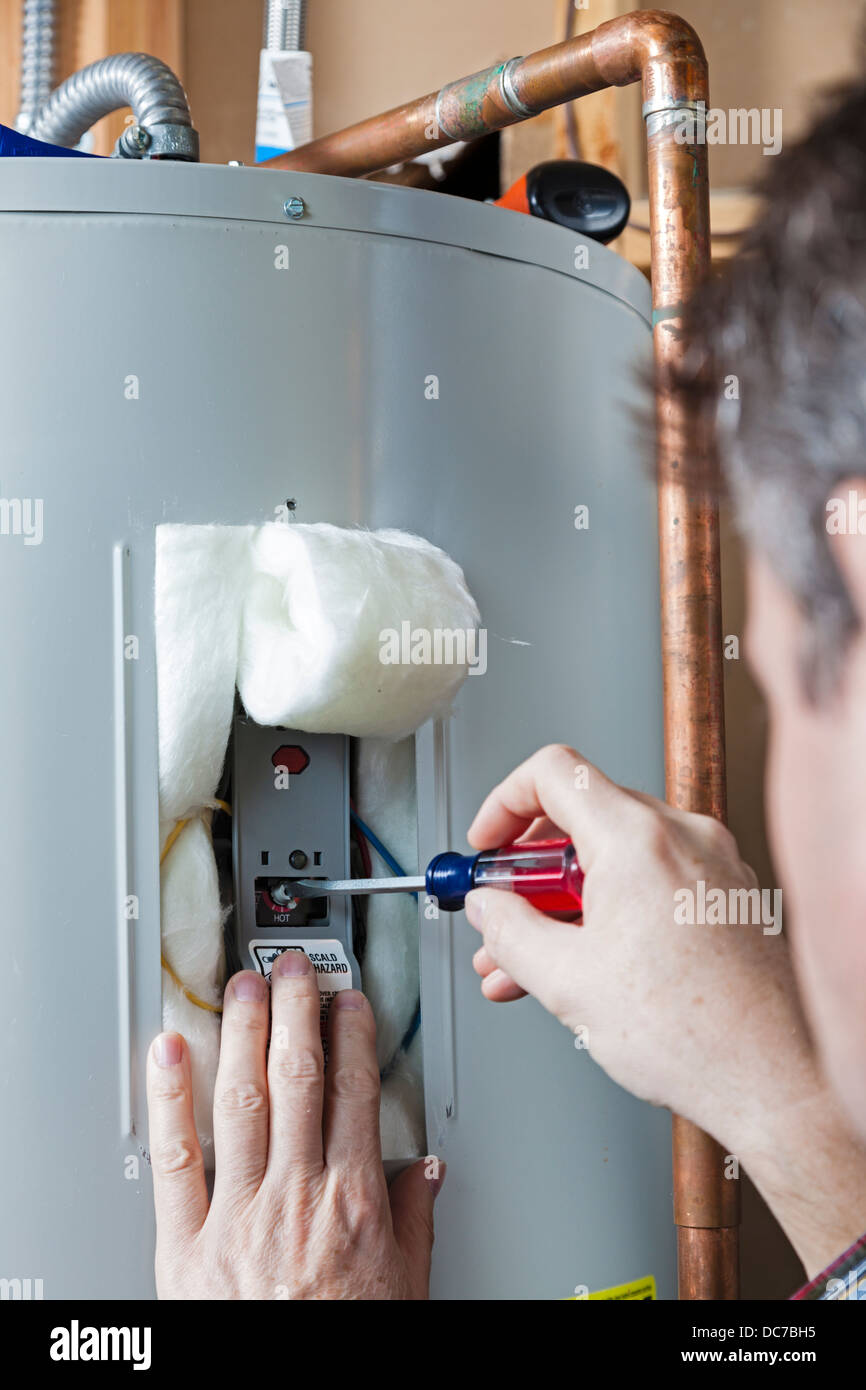 Water heater maintenance Stock Photo