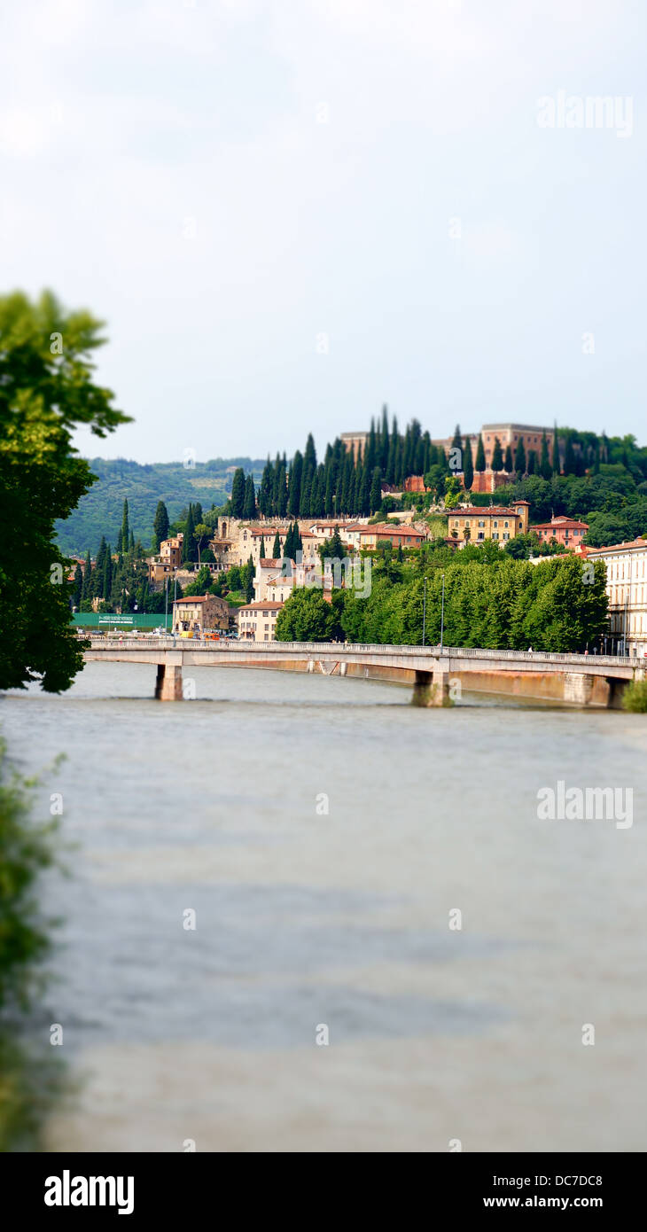 Tilt-shift photography of Verona cityscape, bell tower, river, and bridge. Stock Photo