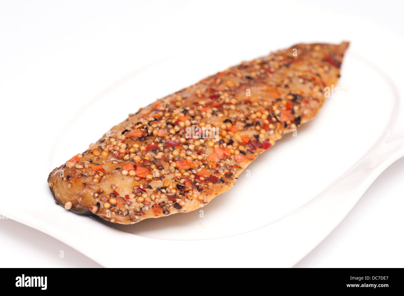 Smoked mackerel with peppercorns and mustard seeds Stock Photo