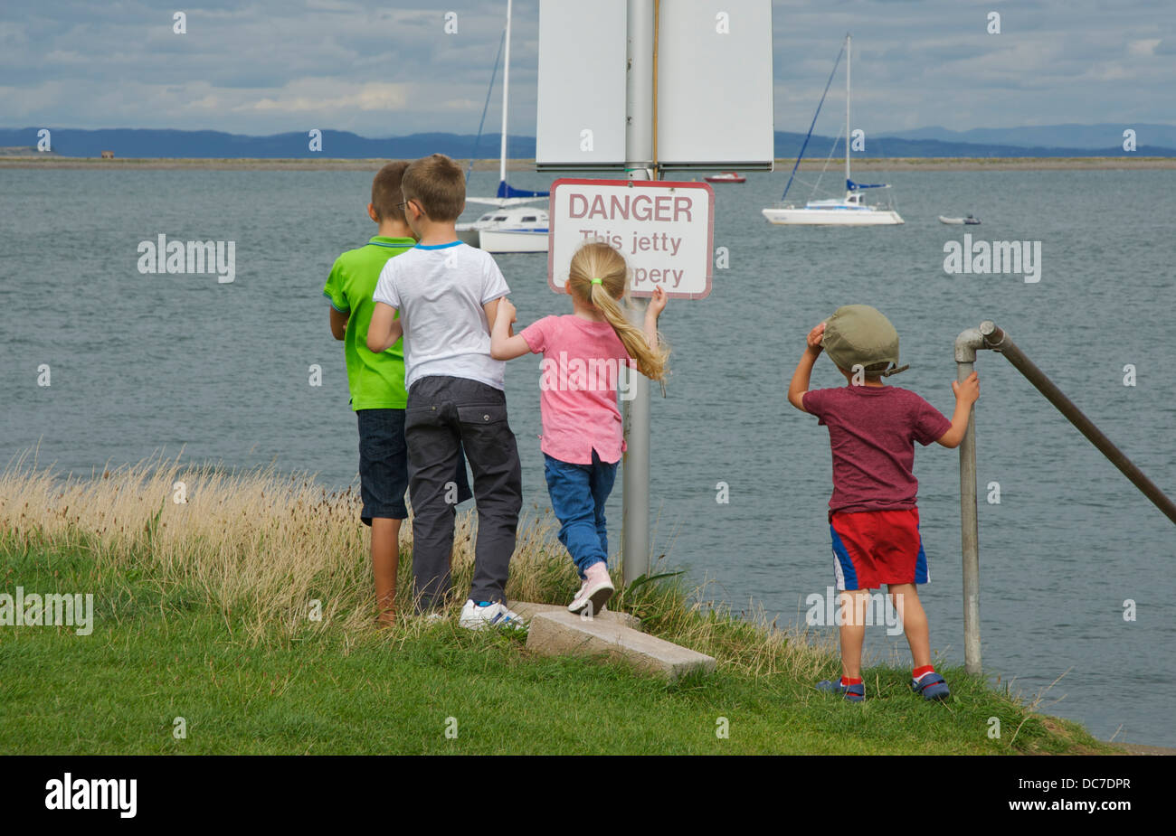 Four children playing on Piel Island, South Lakeland, Cumbria, England uk Stock Photo