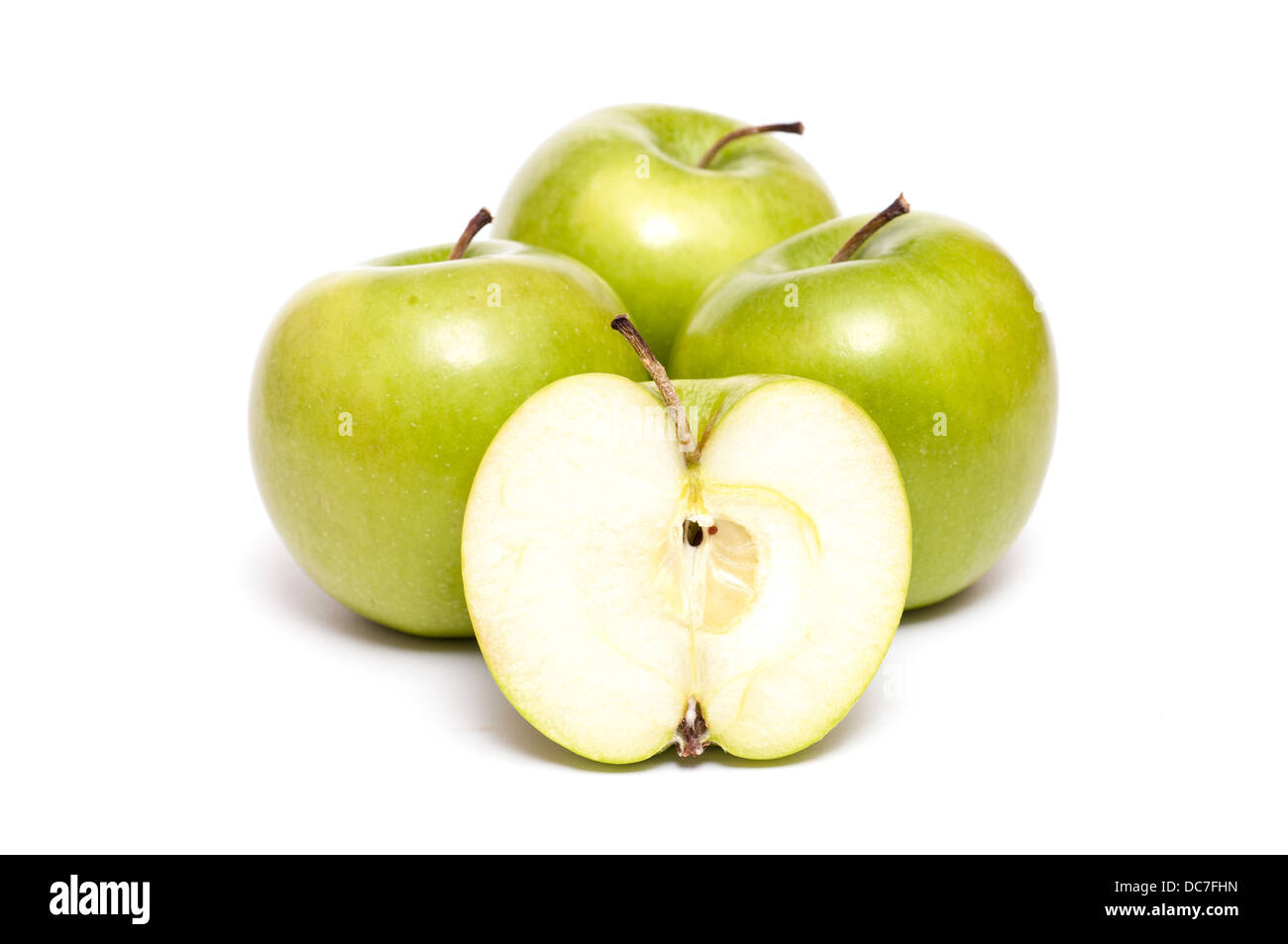 Four apples on a white background and one is sliced Stock Photo